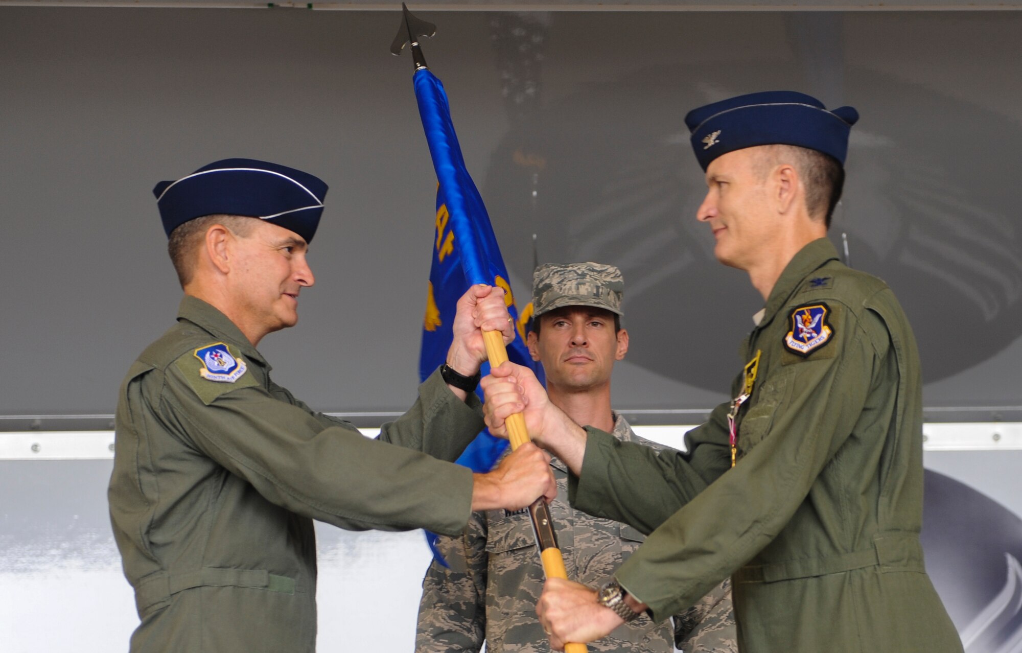 U.S. Air Force Maj. Gen. H.D. Polumbo, 9th Air Force commander, receives the guidon from Col. Billy Thompson, outgoing 23d Wing commander, during a change of command ceremony at Moody Air Force Base, Ga., July 12, 2013. The flag is exchanged from the outgoing commander to the incoming commander as a symbol of relinquishing and accepting command. (U.S. Air Force photo by Airman Alexis Grotz/Released)