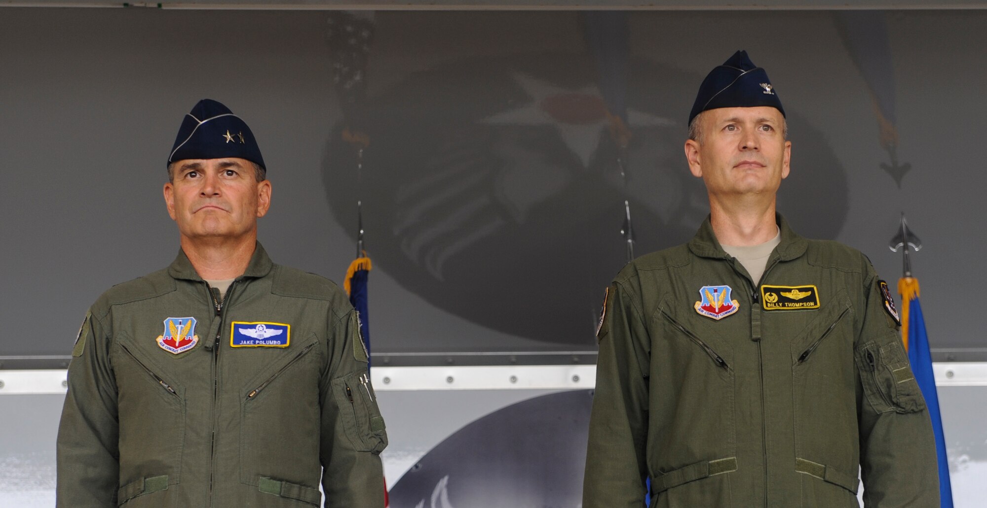 U.S. Air Force Maj. Gen. H.D. Polumbo, 9th Air Force commander, and Col. Billy Thompson, outgoing 23d Wing commander, stand at attention as the master of ceremonies reads Thompsons accomplishments during a change of command ceremony at Moody Air Force Base, Ga., July 12, 2013. Thompson has commanded the 23d Wing for two years and will now become the chief of legislative liaisons to the Senate at Washington, D.C. (U.S. Air Force photo by Airman Alexis Grotz/Released)