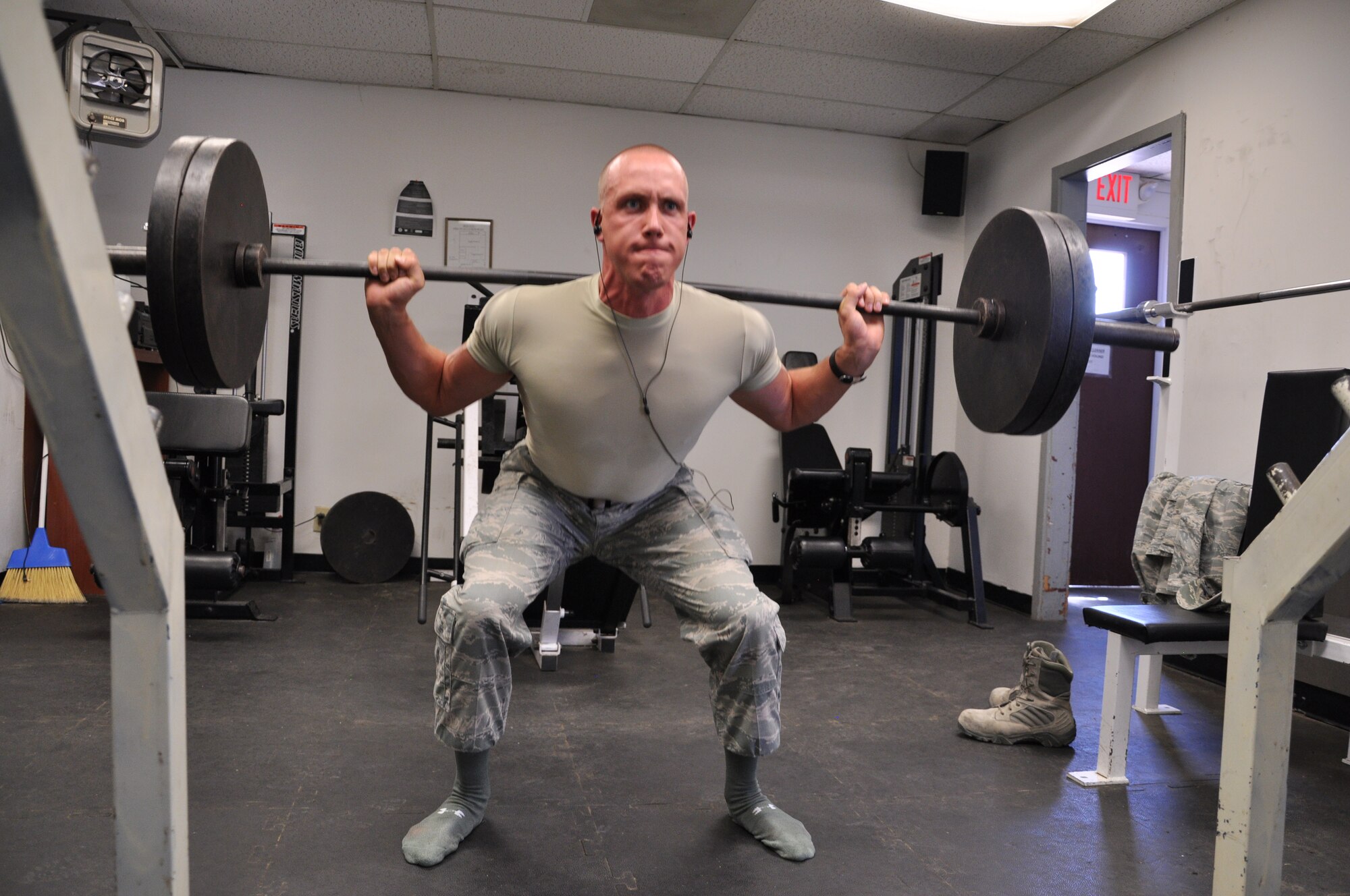 Airman 1st Class Kyle Young, 607th Air Control Squadron cyber transport systems apprentice, squats 225 pounds July 2 as part of his workout at the 607th ACS gym. Young works out ten times a week to maintain fitness. (U.S. Air Force photo/2nd Lt. Candice Dillitte)