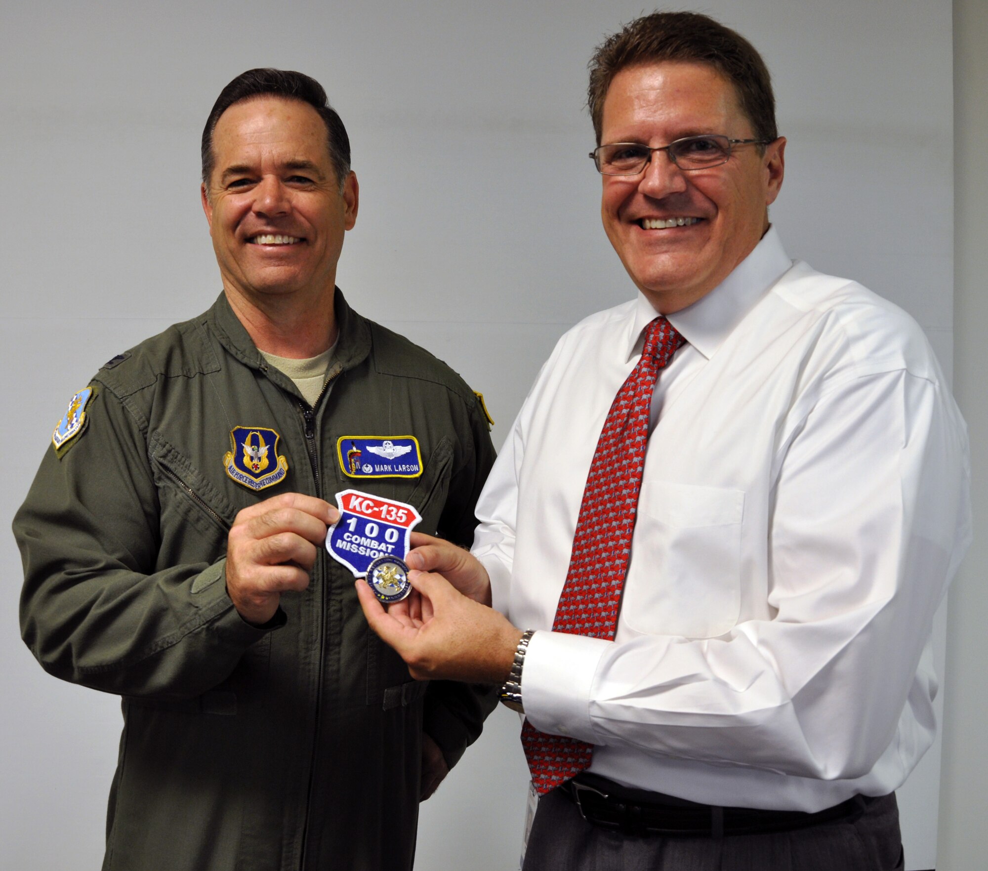 Col. Mark S. Larson, commander of the Air Force Reserve 931st Air Refueling Group, presents a "100 Combat Missions" patch to Bill James of Beechcraft Corporation, July 15, 2013.  Larson, along with several other members of the 931st, presented the patch and a certificate of appreciation to the local employer to thank them for their outstanding support of Lt. Col. Esteban Ramirez, a traditional Reservists employed at Beechcraft, during his recent deployments.  (U.S. Air Force photo by Capt. Zach Anderson)