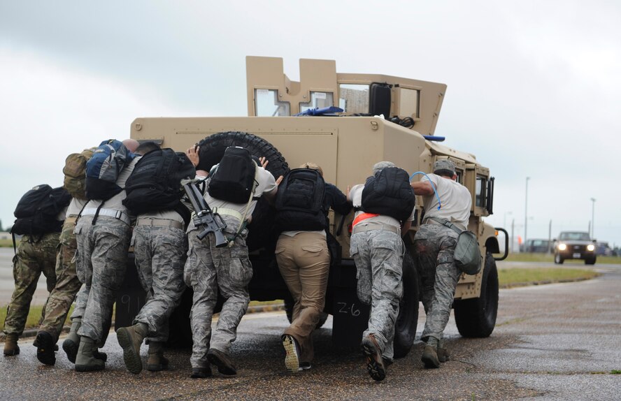 A Monster Mash team pushes a Humvee during the 352nd Special Operations Group Olympics at RAF Mildenhall, England, July 3, 2013. “Nothing brings a group of individuals together like enduring a little bit of suck. It builds teamwork,” said Chief Master Sgt. William Markham, 352nd SOG command chief. (U.S. Air Force photo by Airman 1st Class Preston Webb/Released)