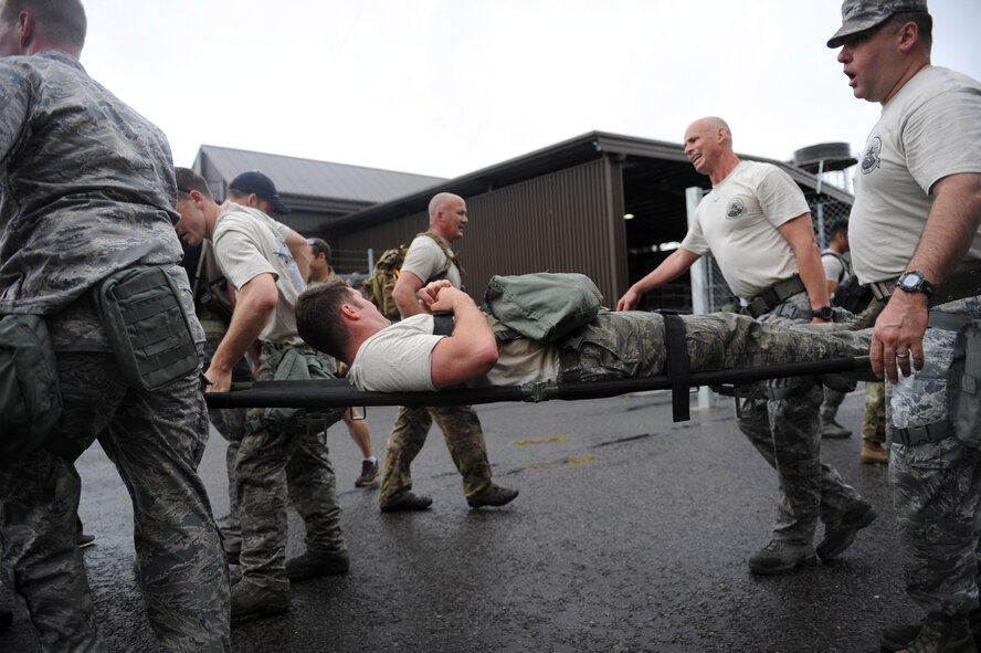 A Monster Mash team carrys one of their “injured” teammates July 3, 2013, during the 352nd Special Operations Group Olympics on RAF Mildenhall, England. The 352nd Special Operations Maintenance Squadron won the 352nd SOG Olympics and was awarded the “SOG Hog.” (U.S. Air Force photo by Airman 1st Class Preston Webb/Released)
