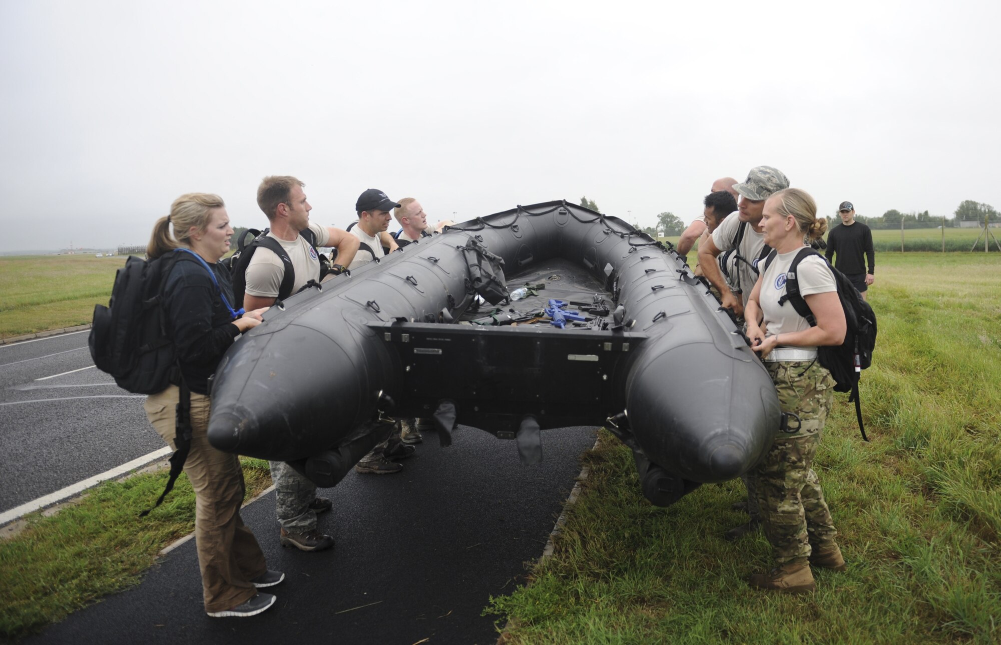 A Monster Mash team lifts a Zodiac inflatable boat July 3, 2013, during the 352nd Special Operations Group Olympics on RAF Mildenhall, England. (U.S. Air Force photo by Airman 1st Class Preston Webb/Released)