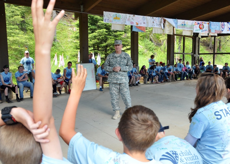 Montana National Guard Adjutant General, Maj. Gen. Matthew Quinn, answers questions posed to him from young campers during Camp Runnamucka, held at Camp Rotary located near Monarch, Mont. on June 27, 2013. (Air Force photo/Senior Master Sgt. Eric Peterson)

