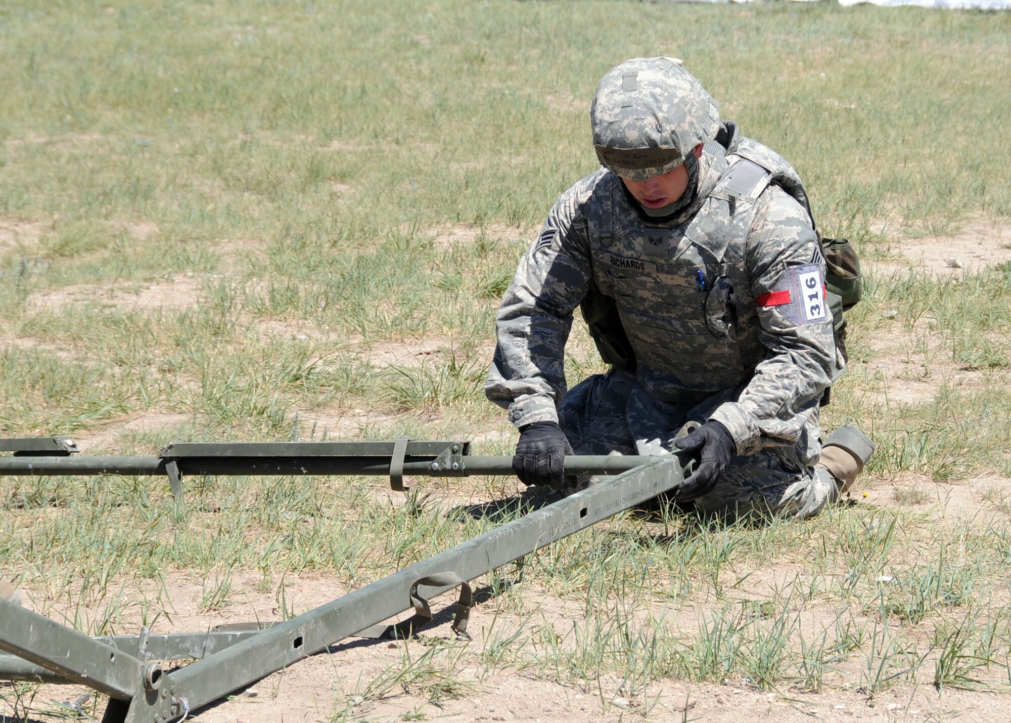 Senior Airman Josiah Richards, 219th RED HORSESquadron member, erects a temper tent during a field training exercise at Fort Harrison, Mont. June 10, 2013  The squadron participated in contingency training during their unit training assembly.  (U.S. Air Force photo/2nd Lt Robin Jirovsky)