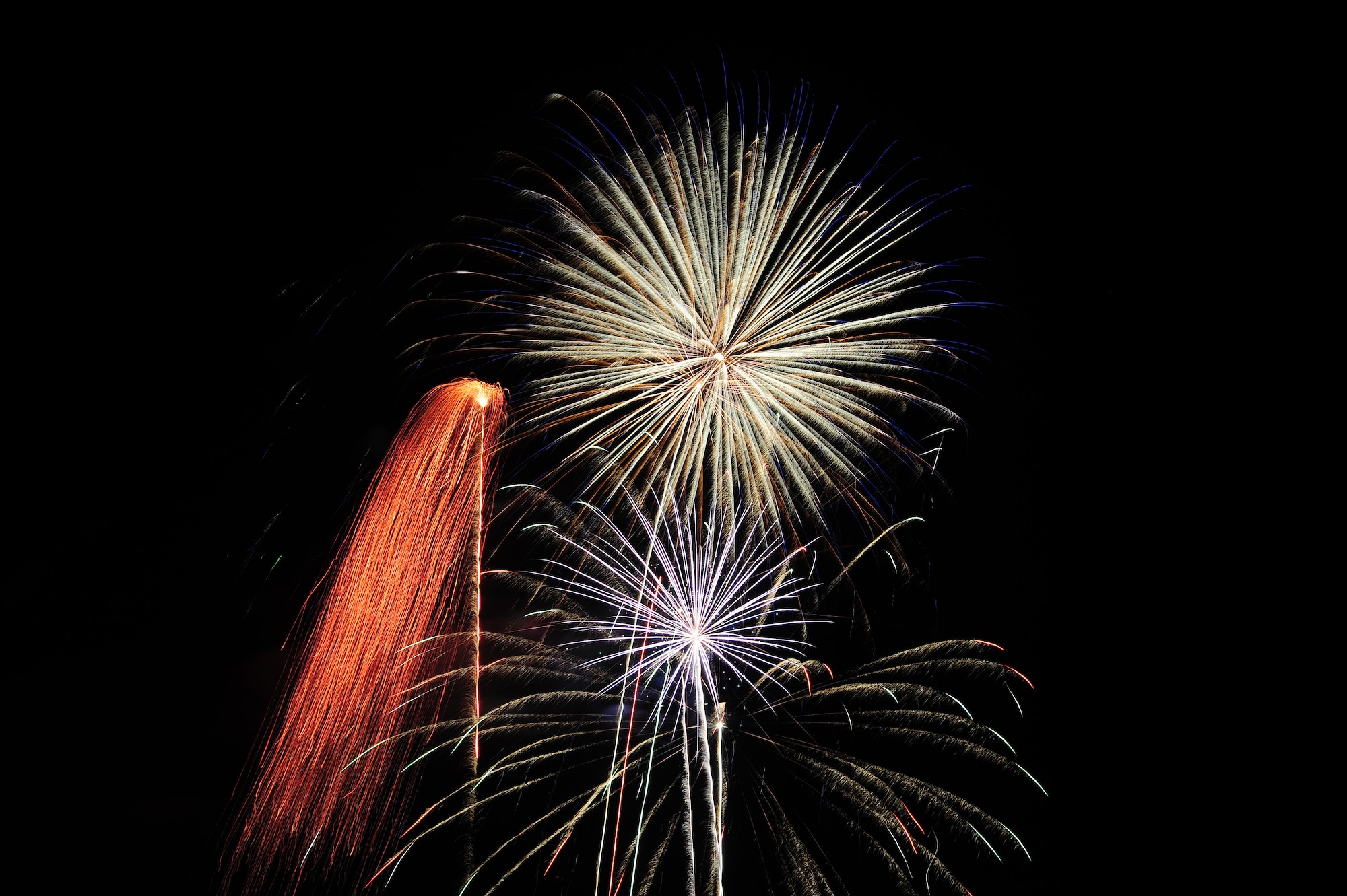 Fireworks are blasted during a 4th of July celebration at Whiteman Air Force Base, Mo., July 3, 2013. In addition to fireworks, the event included face painting, a car show, a petting zoo and bouncy castles for children to play on. (U.S. Air Force photo by Staff Sgt. Nick Wilson/Released)
