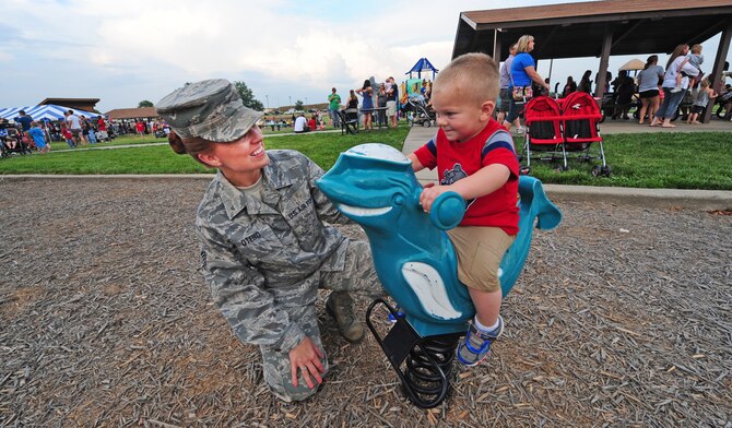Staff Sgt. Kira Otero, 509th Force Support Squadron, plays with her son during a 4th of July celebration at Whiteman Air Force Base, Mo., July 3, 2013. The day included a number of activities including karaoke with a live disk jockey, free games, rides, contests with prizes and a fireworks display. (U.S. Air Force photo by Staff Sgt. Nick Wilson/Released)
