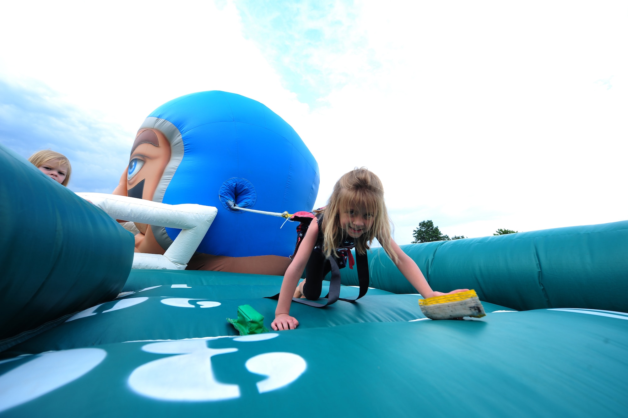 Trinity Foote, daughter of Tech. Sgt. Derrick Foote, 509th Contracting Squadron, plays a game of human tug of war during a 4th of July celebration at Whiteman Air Force Base, Mo., July 3, 2013. This was one of many free activities included in the afternoon’s events. (U.S. Air Force photo by Staff Sgt. Nick Wilson/Released)