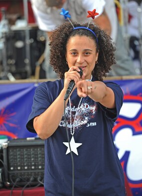 Aleiram Castro, 509th Force Support Squadron, sings during a 4th of July celebration at Whiteman Air Force Base, Mo., July 3, 2013. The event included a number of activities such as pony rides, a fireworks display, karaoke, face painting and games for adults and young children. (U.S. Air Force photo by Staff Sgt. Nick Wilson/Released)