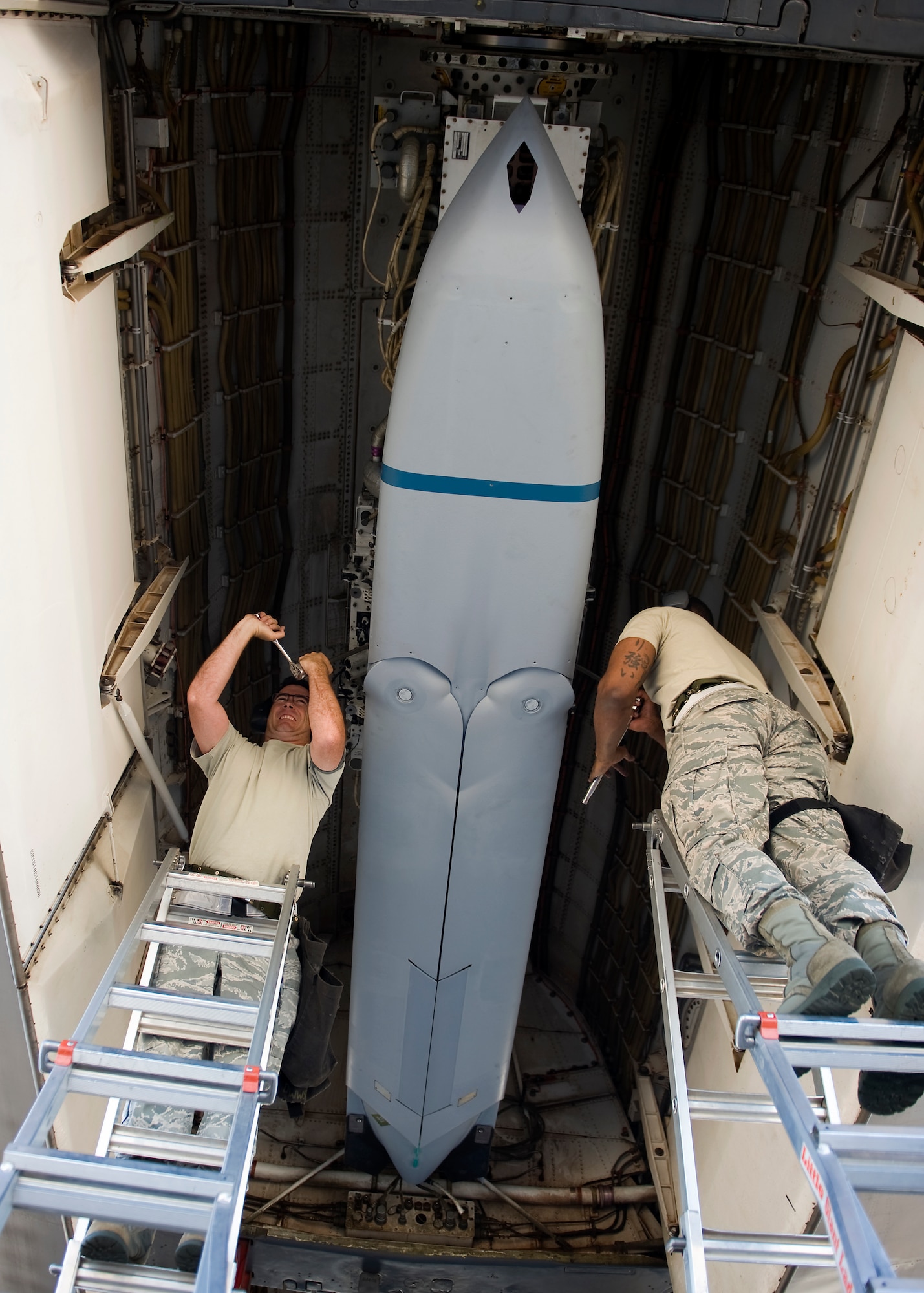U.S. Air Force Master Sgt. Troy Drasher (left) and Tech. Sgt. Alfred Agee both from the 7th Maintenance Group load a Long Range Anti-Ship Missile (LRASM) into the bomb bay of a B-1 Bomber June 12, 2013, at Dyess Air Force Base, Texas. Unlike current anti-ship missiles the LRASM will be capable of conducting autonomous targeting, relying on on-board targeting systems to independently acquire the target without the presence of prior, precision intelligence, or supporting services like Global Positioning Satellite navigation and data-links. These capabilities will enable positive target identification, precision engagement of moving ships and establishing of initial target cueing in extremely hostile environment. (U.S. Air Force photo by Airman 1st Class Damon Kasberg/Released)
