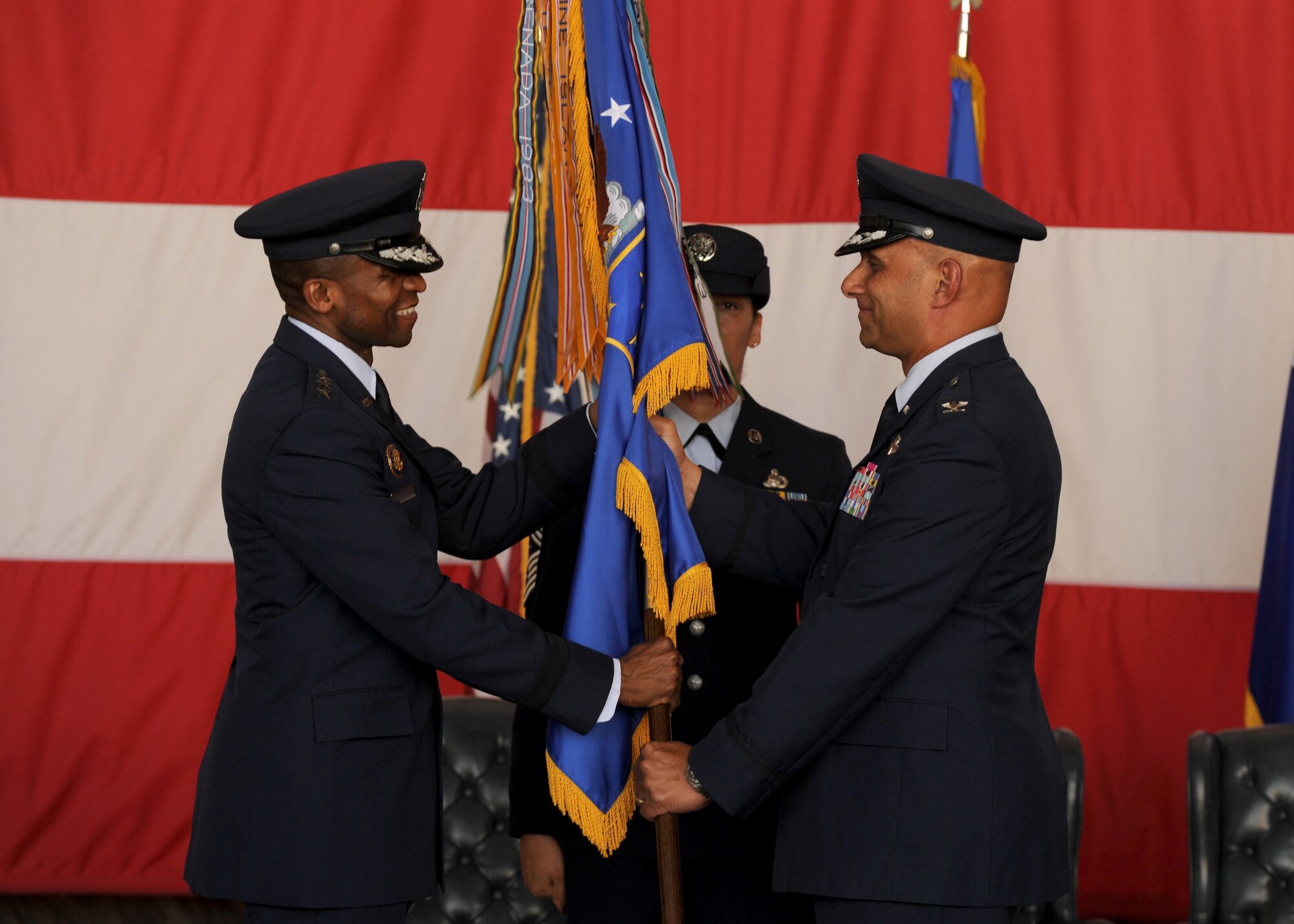 Col. Brian Robinson (right) relinquishes command of the 19th Airlift Wing July 9, 2013, at Little Rock Air Force Base, Ark. Lt. Gen. Darren McDew,  18th Air Force commander, officiated the change of command ceremony for the host unit of the base. (U.S. Air Force photo by Airman 1st Class Scott Poe)