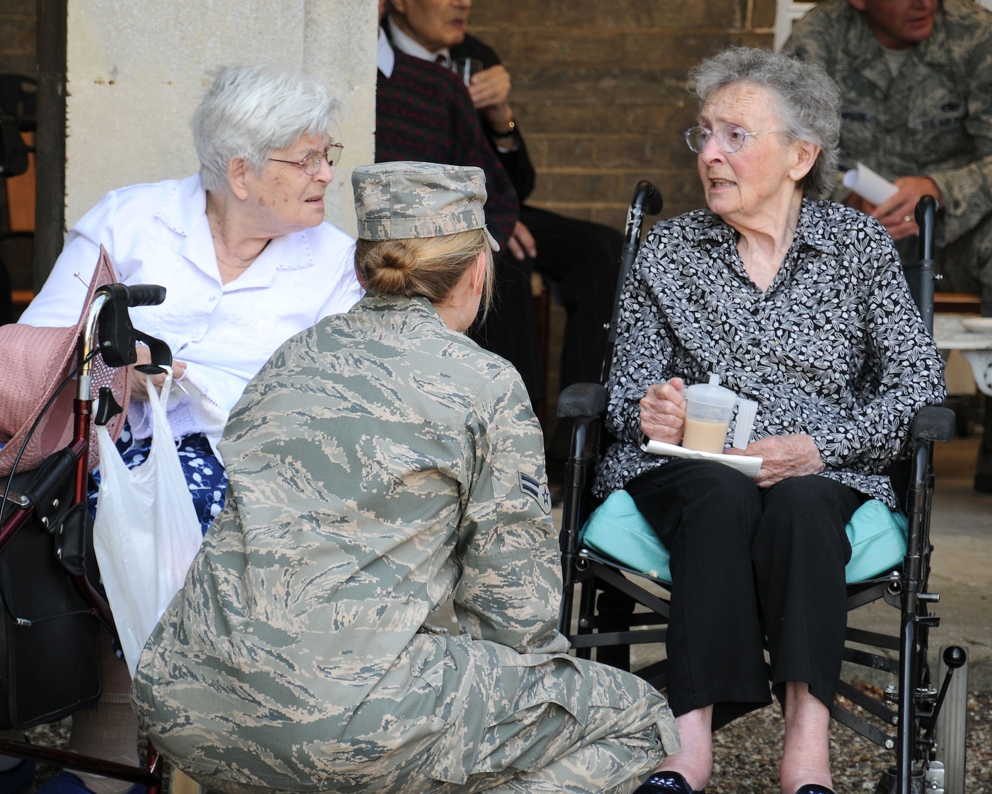 Airman 1st Class Breanna Wallace, 100th Civil Engineer Squadron emergency management apprentice from Lostine, Ore., speaks with two residents at Stowlangtoft Hall nursing home July 11, 2013, in Suffolk, England. Twelve service members and Department of Defense personnel from Team Mildenhall volunteered to speak to residents, some of whom are Royal Air Force veterans, about their time in the U.S. Air Force. (U.S. Air Force photo by Gina Randall/Released)