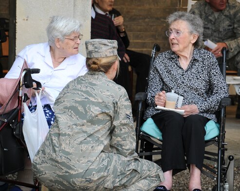 Airman 1st Class Breanna Wallace, 100th Civil Engineer Squadron emergency management apprentice from Lostine, Ore., speaks with two residents at Stowlangtoft Hall nursing home July 11, 2013, in Suffolk, England. Twelve service members and Department of Defense personnel from Team Mildenhall volunteered to speak to residents, some of whom are Royal Air Force veterans, about their time in the U.S. Air Force. (U.S. Air Force photo by Gina Randall/Released)