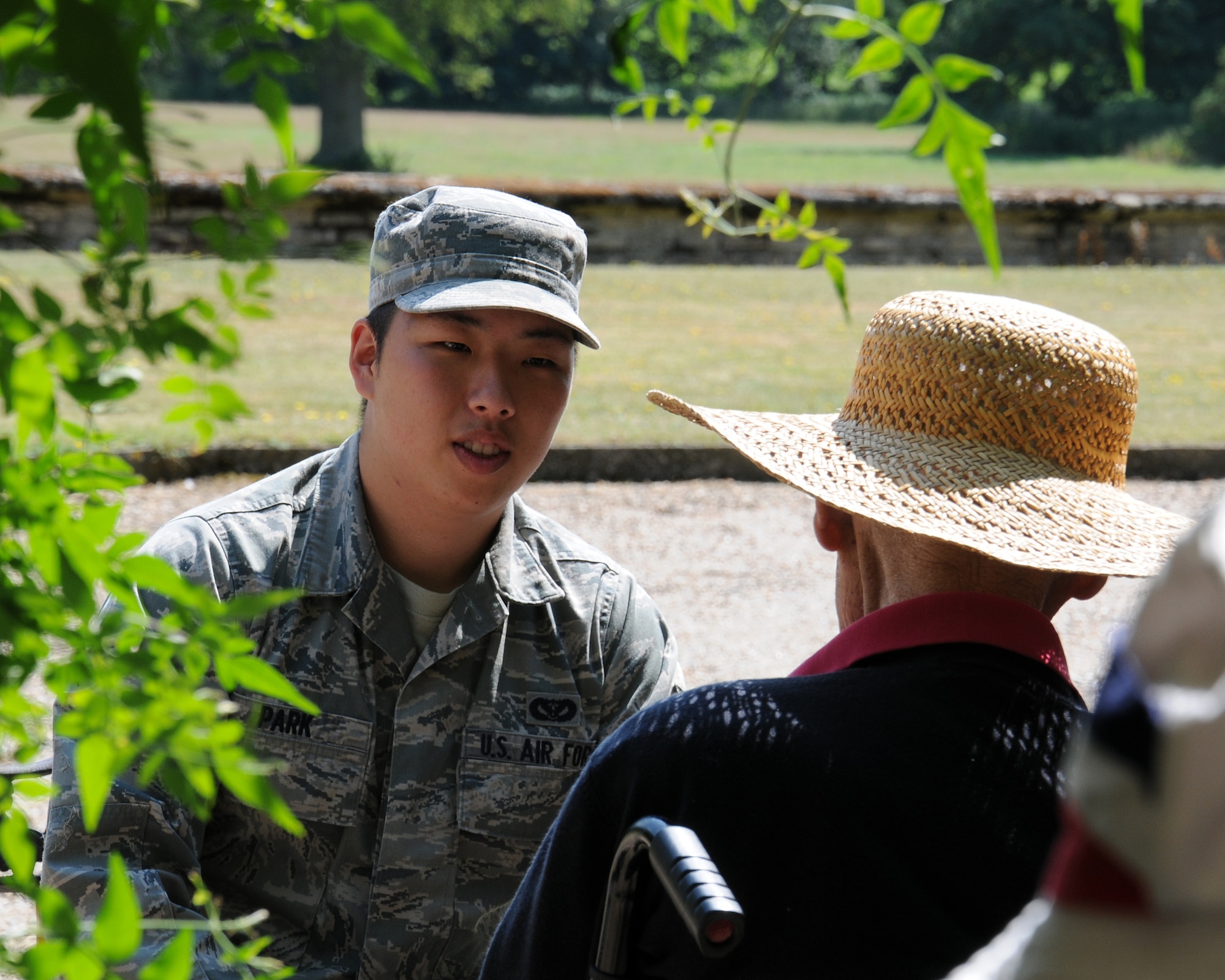 Senior Airman Young Park, 100th Civil Engineer Squadron engineering technician from Horsham, Pa., shares stories and experiences with a resident at Stowlangtoft Hall nursing home July 11, 2013, in Suffolk, England. Twelve service members and Department of Defense personnel from Team Mildenhall volunteered to speak to residents, some of whom are Royal Air Force veterans, about their time in the U.S. Air Force. Service members also assisted nursing home staff by helping the residents outside to sit in the sunshine. (U.S. Air Force photo by Gina Randall/Released)