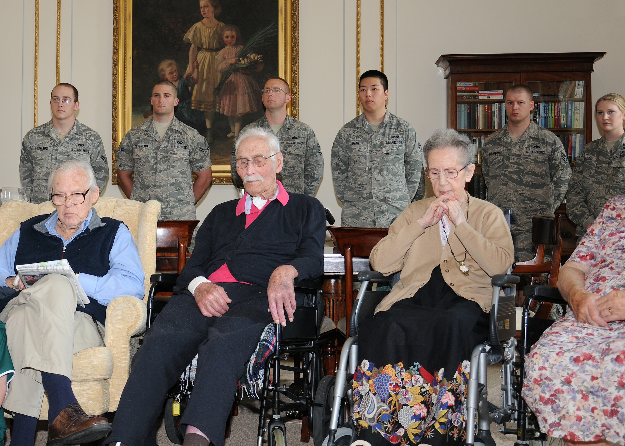 Service members and residents listen to stories about World War II during a visit to Stowlangtoft Hall nursing home July 11, 2013, in Suffolk, England. Twelve service members and Department of Defense personnel from Team Mildenhall volunteered to speak to residents, some of whom are Royal Air Force veterans, about their time in the U.S. Air Force. RAF Mildenhall service members also read stories from the bloody 100th’s mission during the war. (U.S. Air Force photo by Gina Randall/Released)