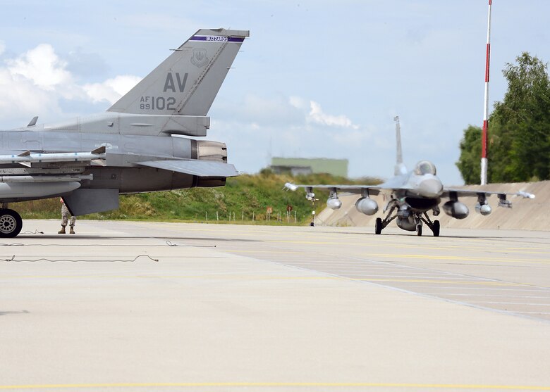 LASK AIR BASE, Poland -- U.S. Air Force F-16 Fighting Falcon fighter aircraft taxi off of the flightline here July 12, 2013. Detachment 1, 52nd Operations Group serves as a training hub for U.S. and Polish aircrew. This third rotation of aircraft is from the 510th Fighter Squadron out of Aviano Air Base, Italy. The first rotation included the C-130J Super Hercules cargo aircraft from Ramstein Air Base, Germany, and the second rotation were F-16s from the Wisconsin Air National Guard. (U.S. Air Force photo by Staff Sgt. Daryl Knee/Released)
