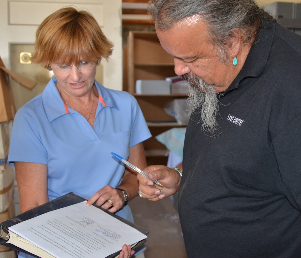 GALLUP, N.M., -- Ronald Maldonado, supervisory archaeologist for the Navajo Nation Historic Preservation Department and Julie Price, cultural resources project manager, U.S. Army Corps of Engineers, Omaha District, complete the paperwork transferring 425 sacred relics to the Navajo Nation July 9, 2013.