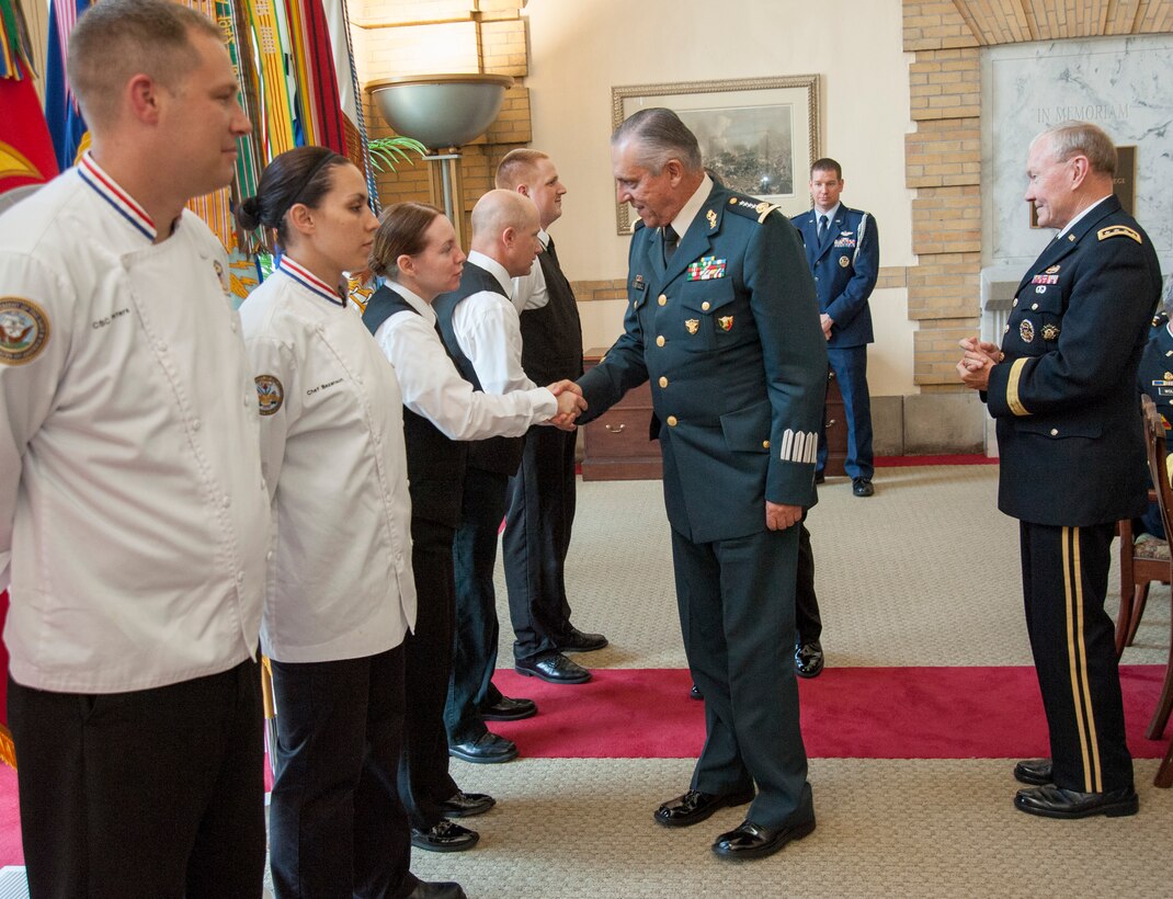 U.S. Army Gen. Martin E. Dempsey, chairman of the Joint Chiefs of Staff, watches as Mexico's Defense Secretary army Gen. Salvador Cienfuegos Zepeda greets people during the U.S.-Mexico Defense Chiefs Strategy Dialogue at the National Defense University on Fort McNair in Washington, D.C., 15 July, 2013. 