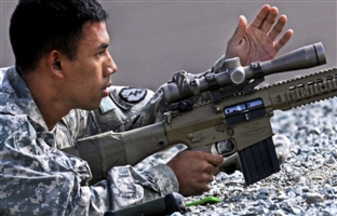 Army Spc. Steve Le makes a correction to his scope during the final day of qualifications for the M110 semi-automatic sniper system on Joint Base Elmendorf-Richardson's Grezelka Range, Alaska, July 10, 2013. Le is assigned to the 25th Infantry Division's 1st Squadron, 40th Cavalry Regiment, 4th Brigade Combat Team. 