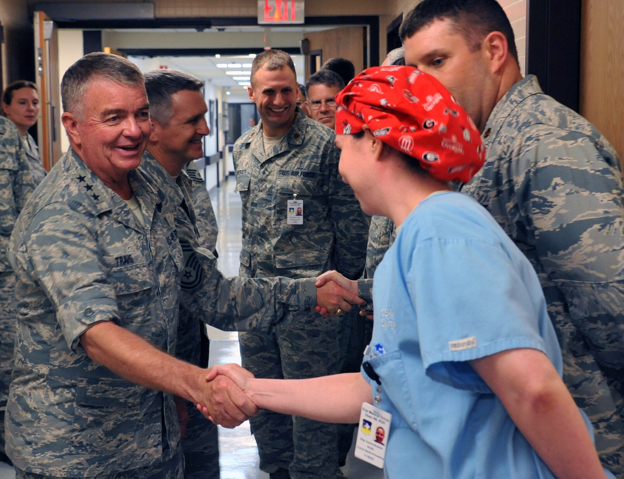 Lt. Gen. Thomas Travis, Air Force surgeon general, shakes hands with the operating room staff during a walk-through of the 51st Medical Group during his visit to Osan Air Base, Republic of Korea, July 15, 2013. The surgeon general also coined several members during his visit to the medical facility for their individual accomplishments. (U.S. Air Force photo/Senior Airman Kristina Overton)
