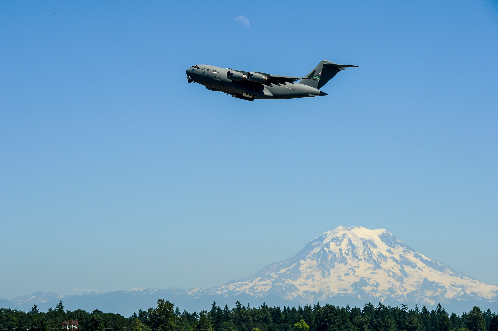 A C-17 Globemaster III ascends over McChord Field as Mt. Rainier towers in the distance, July 15, 2013, at Joint Base Lewis-McChord, Wash. The C-17, piloted by Col. Wyn Elder, 62nd Airlift Wing commander during his "fini flight," was performing a touch-and-go prior to its final approach. (U.S. Air Force photo/TSgt Sean Tobin)