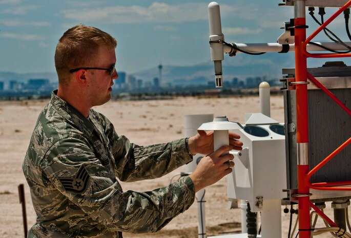 U.S. Air Force Staff Sgt. Corie Brassfield, 99th Communications Squadron airfield systems technician, inspects a relative humidity sensor July 15, 2013, at Nellis Air Force Base, Nev. A humidity sensor takes in air and moisture to tell 57th Operations Support Squadron Weather Flight Airmen what the temperature feels like outside. (U.S. Air Force photo by Senior Airman Daniel Hughes)