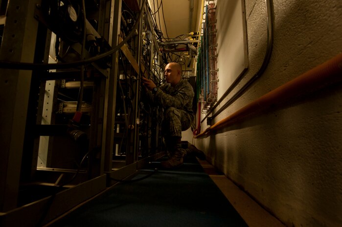 U.S. Air Force Staff Sgt. Benjamin Estes, 99th Communications Squadron airfield systems technician, checks the transmit receive relay for any frequencies July 15, 2013, at Nellis Air Force Base, Nev. The relay enables frequencies to receive and leave the radio to enable clear communication between pilots and air traffic controllers. (U.S. Air Force photo by Senior Airman Daniel Hughes)