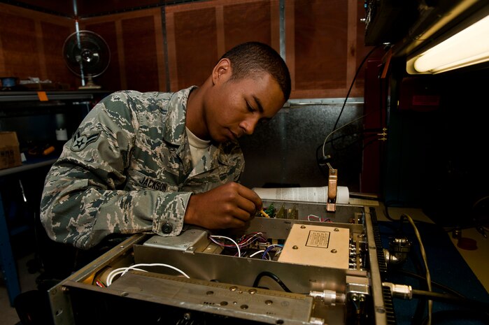 U.S. Air Force Airman 1st Class Bruce Jackson, 99th Communications Squadron airfield systems technician, checks a communication radio for any problems July 15, 2013, at Nellis Air Force Base, Nev. Jackson performs maintenance on the radio to enable reliable communication between pilots and the air traffic control tower. (U.S. Air Force photo by Senior Airman Daniel Hughes) 
