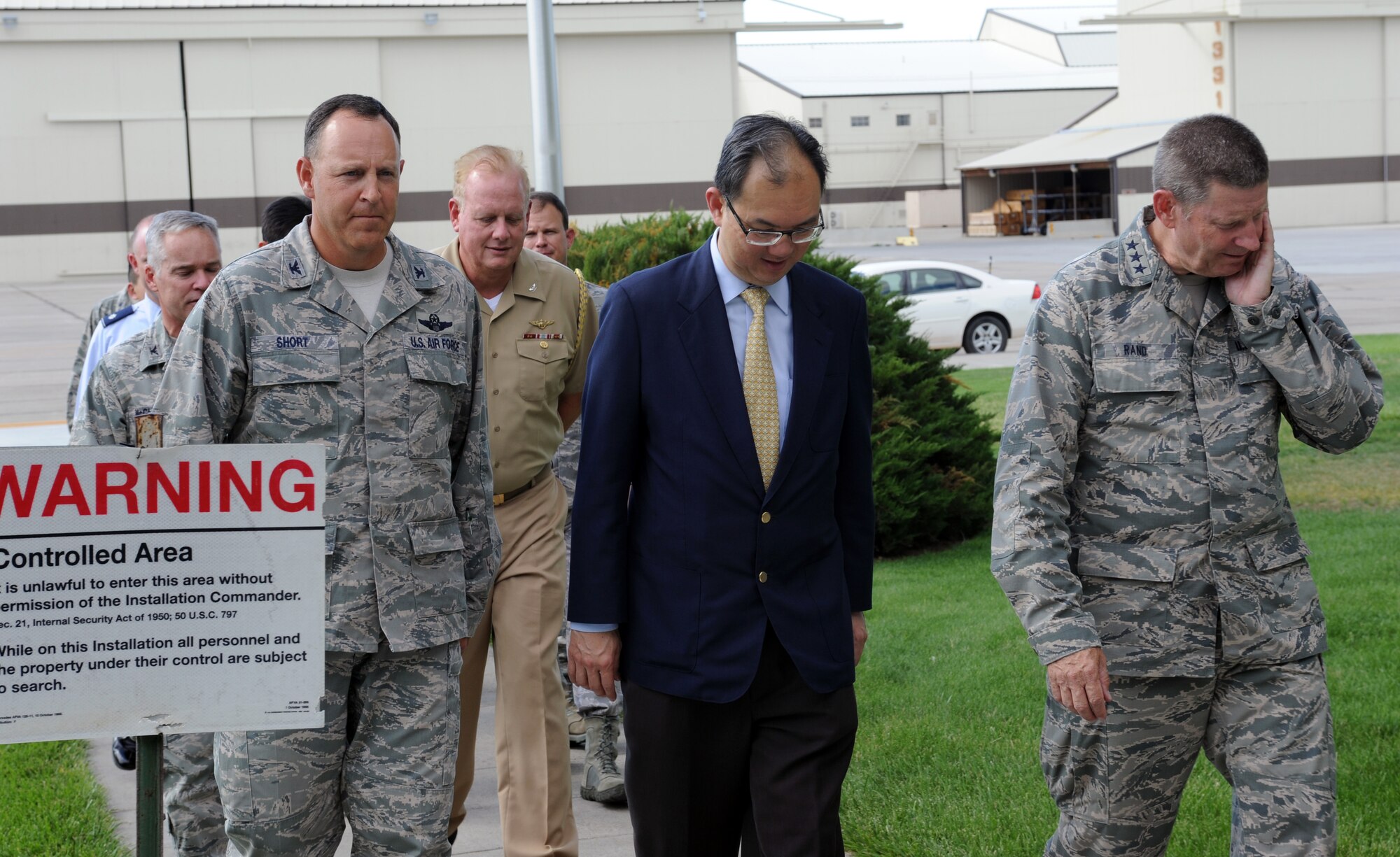 From left, U.S Air Force Col. Christopher Short, 366th Fighter Wing commander, Mr. Chiang Chie Foo, Republic of Singapore Permanent Secretary (Defence), and Lt. Gen. Robin Rand, 12th Air Force commander, walk during a tour July 15, 2013, at Mountain Home Air Force Base, Idaho. General Rand and Mr. Foo's tour included stops at the Gunfighter Club and Wing Headquarters building. (U.S. Air Force photo by Senior Airman Benjamin Sutton/ Released)
