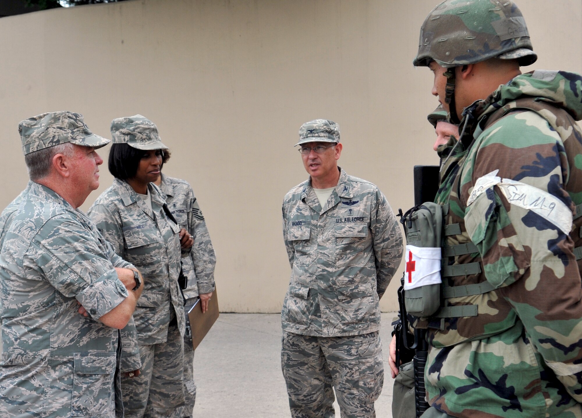 Col. Rawson Wood, 51st Medical Group commander, briefs Lt. Gen. Thomas Travis, Air Force surgeon general, and Chief Master Sgt. Monica Hill, Pacific Air Forces Medical Enlisted Force chief, on exercise and wartime facility security capabilities during the general’s visit to Osan Air Base, Republic of Korea, July 15, 2013. Members showcased their ability secure their facilities by challenging intruders, and several other demonstrations for the tour, showcasing their proficiency in operations. (U.S. Air Force photo/Senior Airman Kristina Overton)