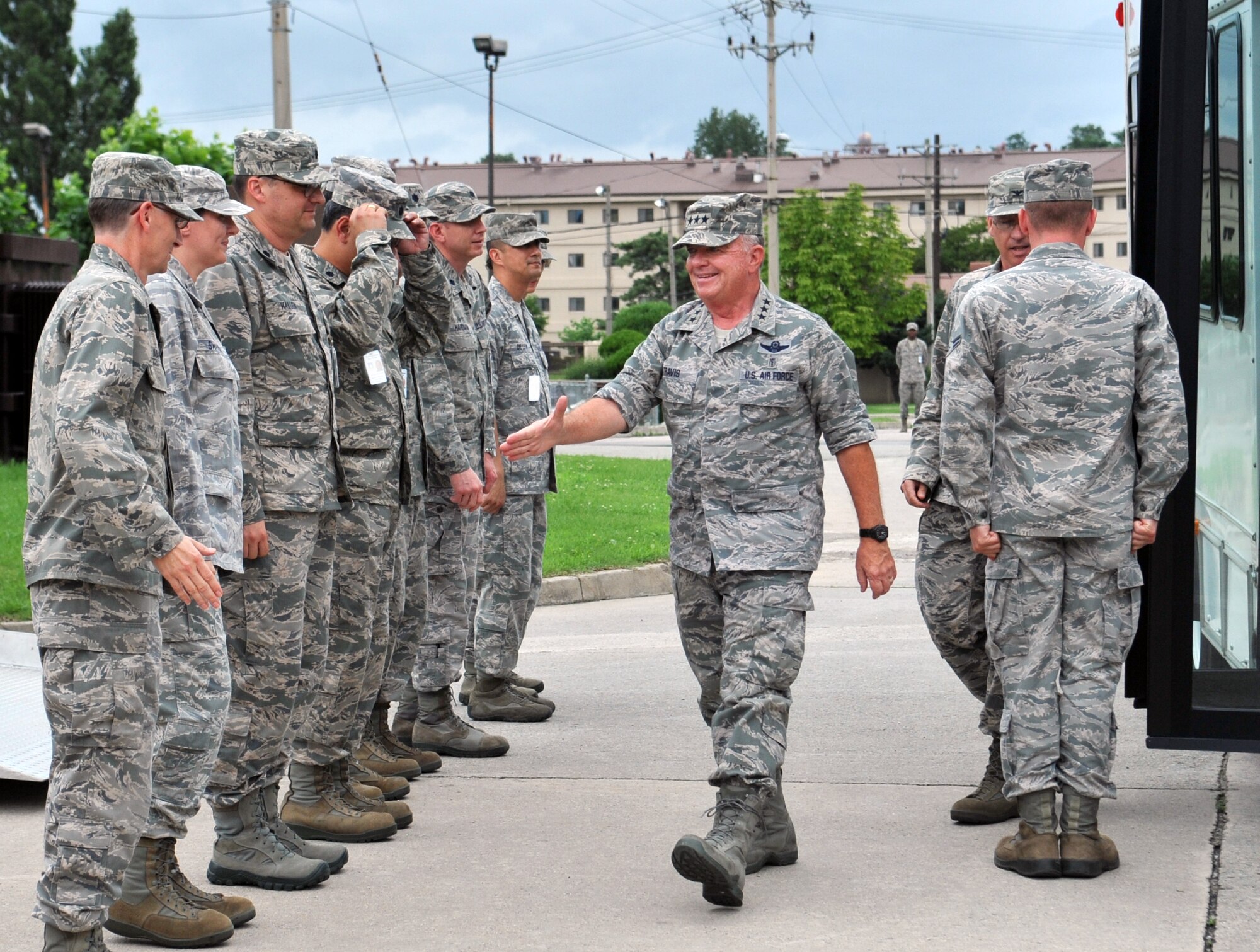 Leadership from the 51st Medical Group wait to greet Lt. Gen. Thomas Travis, Air Force surgeon general, as he arrives at the 51st Medical Group during his visit to Osan Air Base, Republic of Korea, July 15, 2013. The surgeon general was taken on a tour of the medical facility which included the emergency room, radiology, flight medicine, the laboratory, orthopedics and operating rooms. (U.S. Air Force photo/Senior Airman Kristina Overton)