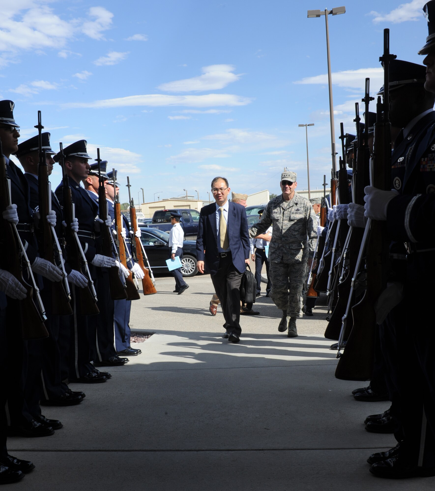 Mr. Chiang Chie Foo, Republic of Singapore Permanent Secretary (Defence), and U.S. Air Force Lt. Gen. Robin Rand, 12th Air Force commander walk into the 428th Fighter Squadron building July 15, 2013, at Mountain Home AIr Force Base, Idaho, between members of the base Honor Guard. All three Honor Guard flights were on hand for the VIP event. (U.S. Air Force photo by Senior AIrman Benjamin Sutton/Released)