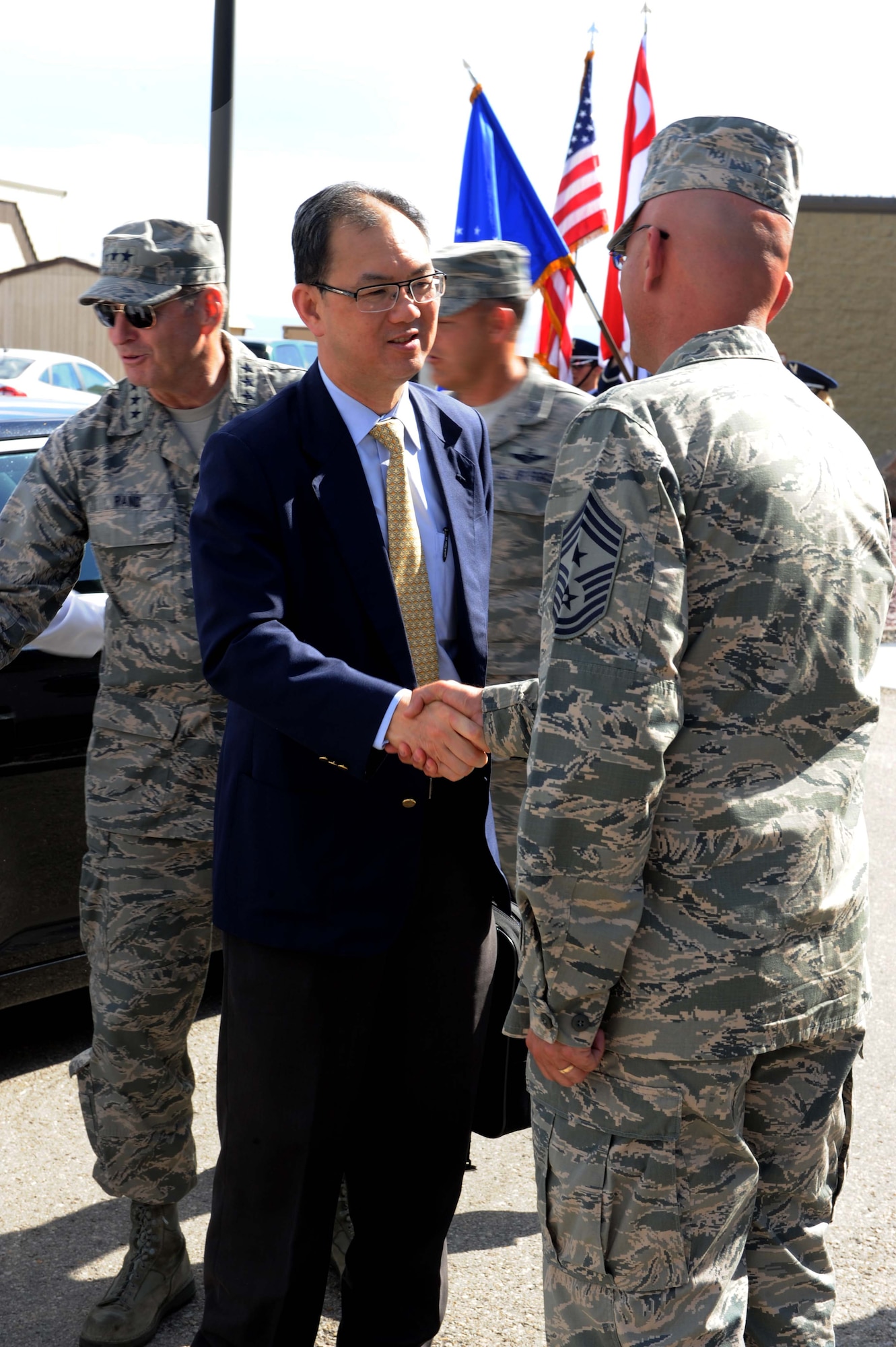 Mr. Chiang Chie Foo, Republic of Singapore Permanent Secretary (Defence), shakes hands with U.S. Air Force Chief Master Sgt. Alexander Del Valle, 366th Fighter Wing command chief, July 15, 2013, at Mountain Home Air Force Base, Idaho. Base leadership showed up to welcome Mr. Foo to the base before he went on his official tour. (U.S. Air Force photo by Senior Airman Benjamin Sutton/Released) 