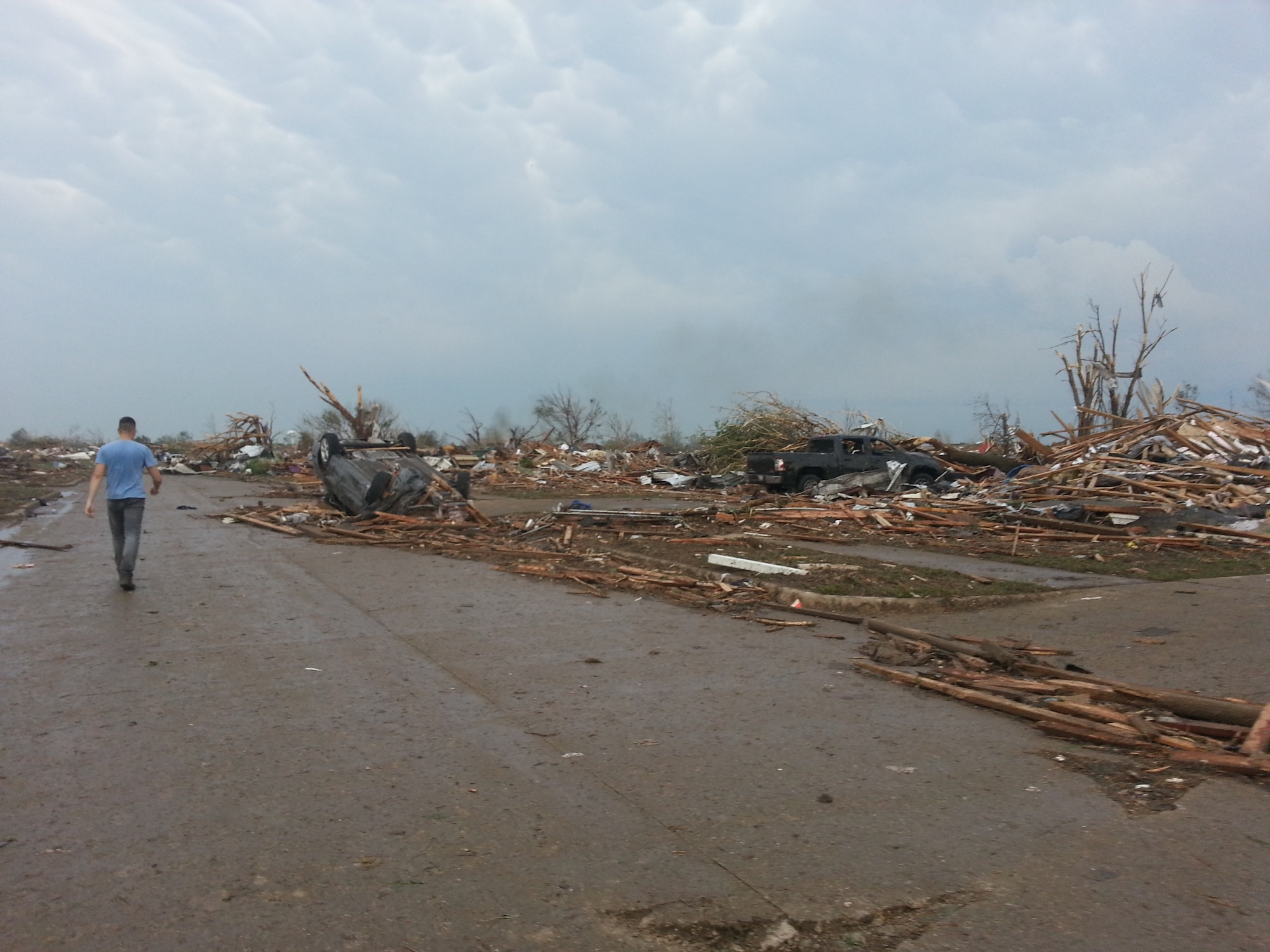 MOORE, Okla. -- A volunteer searches for survivors after an EF-4 tornado struck the area May 20, 2013.  (Courtesy photo)