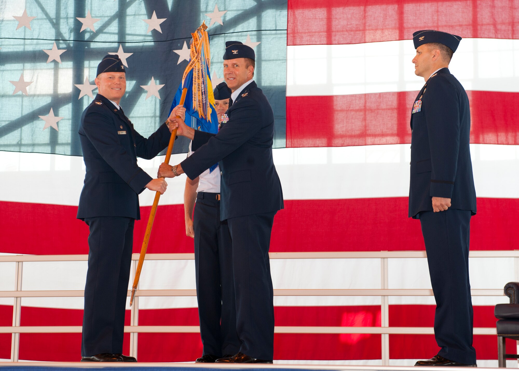 Colonel Kenneth Johnson, 49th Operations Group outgoing commander, passes the 49th Operations Group’s guidon to Col. Andrew Croft, 49th Wing commander, symbolizing stepping down from commanding the group during the 49th Operations Group change of command ceremony at Holloman Air Force Base, N.M., June 12. In the ceremony Col. Mark Hoehn assumed command of the 49th OG from Col. Kenneth Johnson. The group is home to the Air Force’s most combat-ready F-22 Raptor squadron and is a formal training unit for MQ-1 Predator and MQ-9 Reaper aircrew, graduating around 700 crews per year. (U.S. Air Force photo by Airman 1st Class Daniel E. Liddicoet/Released)