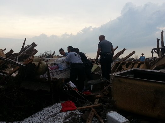 MOORE, Okla. -- Volunteers search for pets amidst debris after an EF-4 tornado struck the area May 20, 2013.  (Courtesy photo)