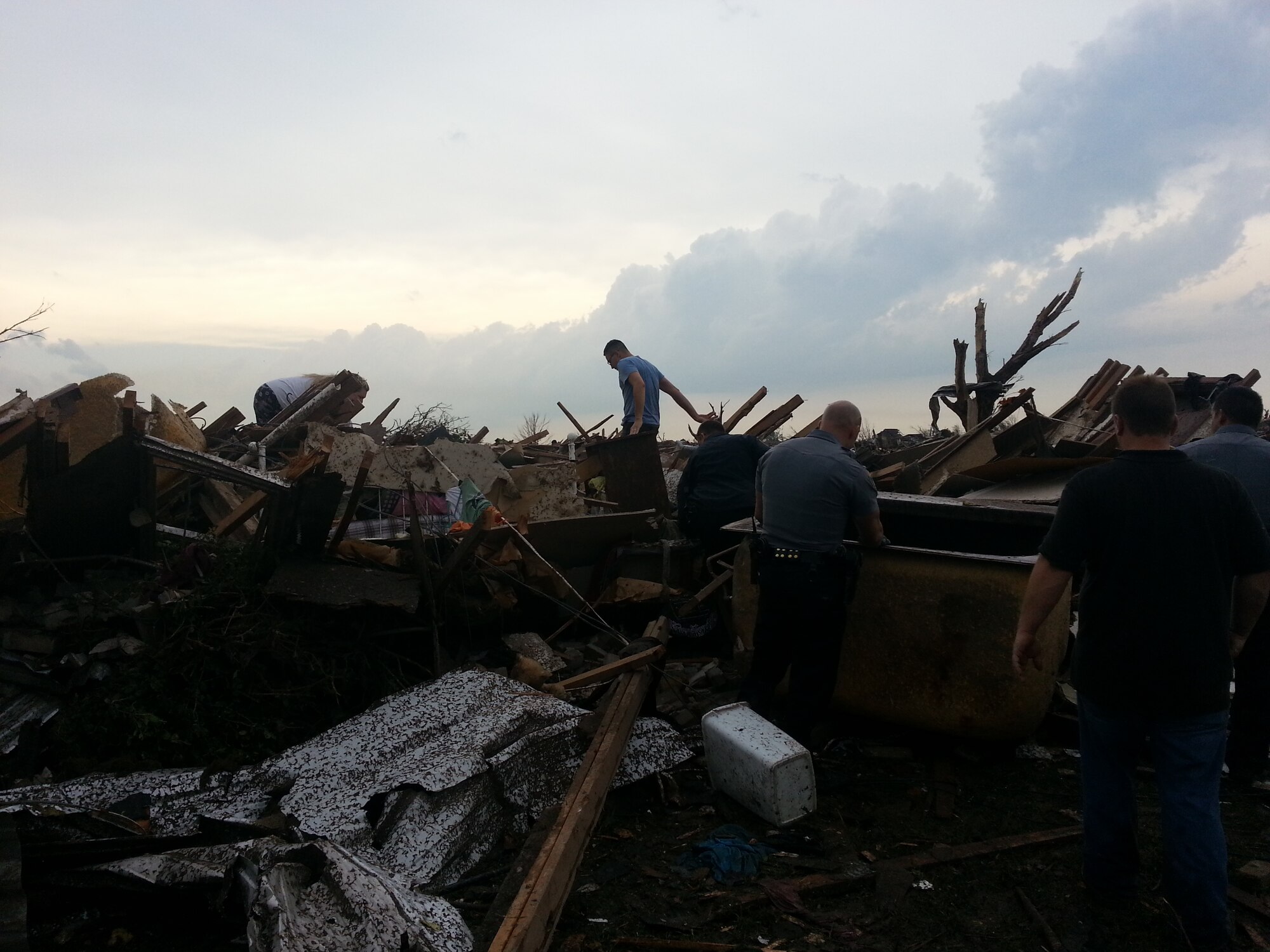 MOORE, Okla. -- Volunteers search for pets amidst debris after an EF-4 tornado struck the area May 20, 2013.  (Courtesy photo)