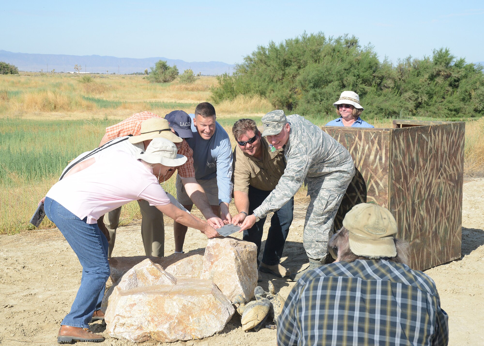 Col. Robert Hoff, 412th Mission Support Group commander (right side) poses for a photo with Ducks Unlimited representatives and freinds of Piute Ponds July 12 during a dedication ceremony at the ponds. Edwards Environmental Management along with Ducks Unlimited and District 14 in Lancaster, Calif., joined forces to construct new water control structures, culverts and dikes that will allow flooding to ponds that have not been used in years. (U.S. Air Force photo by Kenji Thuloweit)