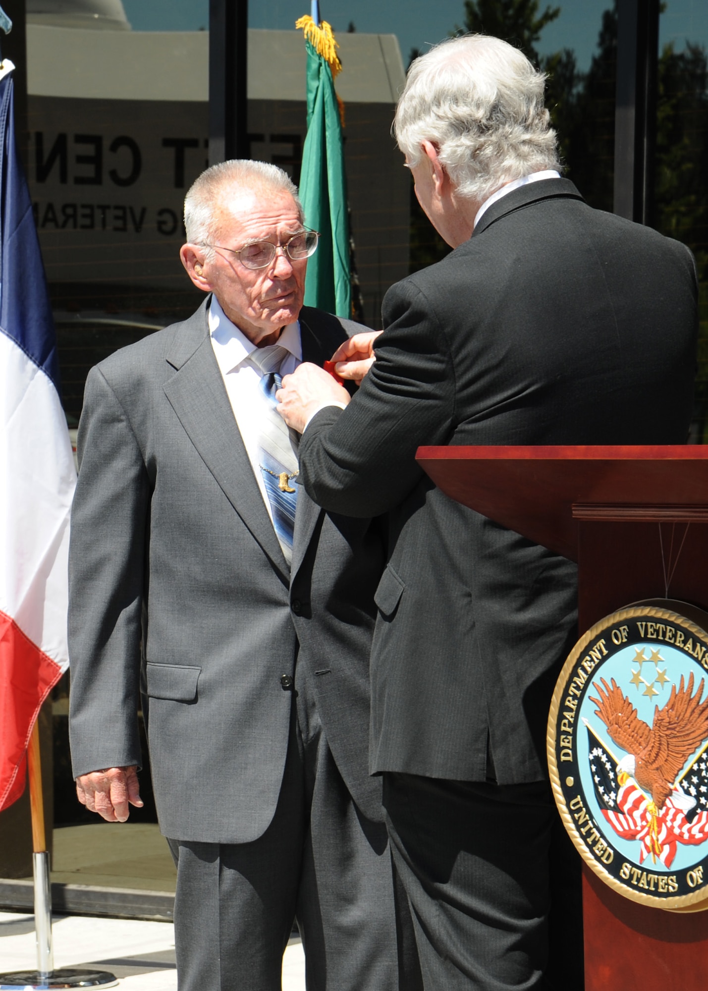 Jack Cowan, Honorary Consul of France, pins the French Legion of Honor medal on Mr. Del Casper, WWII Army Air Corps B-17 gunner, at the Spokane Veterans Center in Spokane Valley, Wash., July 15, 2013.  Casper was honored for his heroism during 35 bombing missions over German-occupied Europe.  (U.S. Air Force photo by Senior Airman Samantha Krolikowski/Released)
