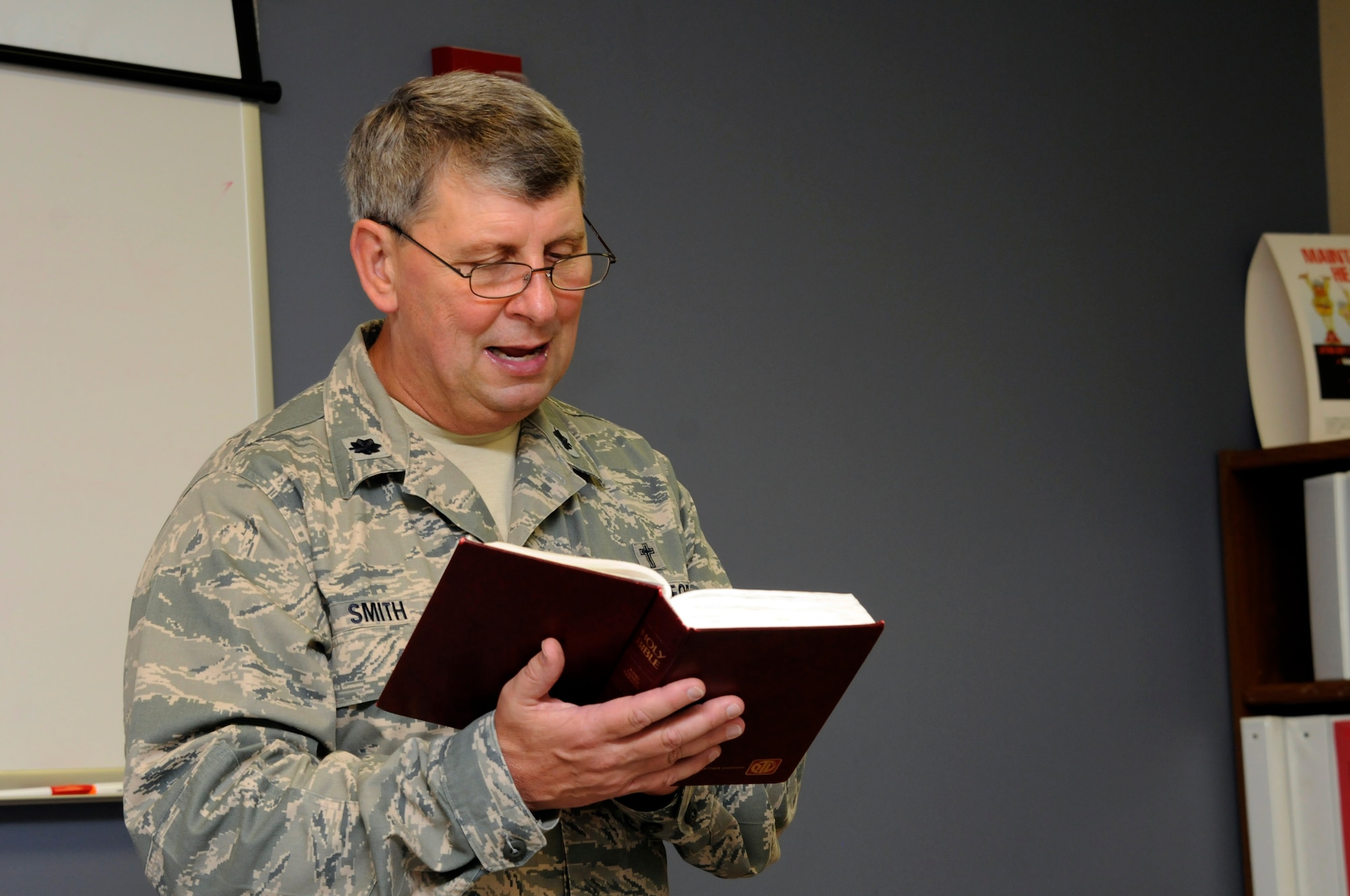 Lt. Col. Thomas Smith, wing chaplain, reads from the Bible during a brown bag lunch bunch Bible study held June 26 at the 188th Fighter Wing. These weekly Bible studies led by Smith bring together unit members for a time to share fellowship, study and eat lunch together. (U.S. Air National Guard photo by 1st Lt. Holli Snyder/188th Fighter Wing Public Affairs)