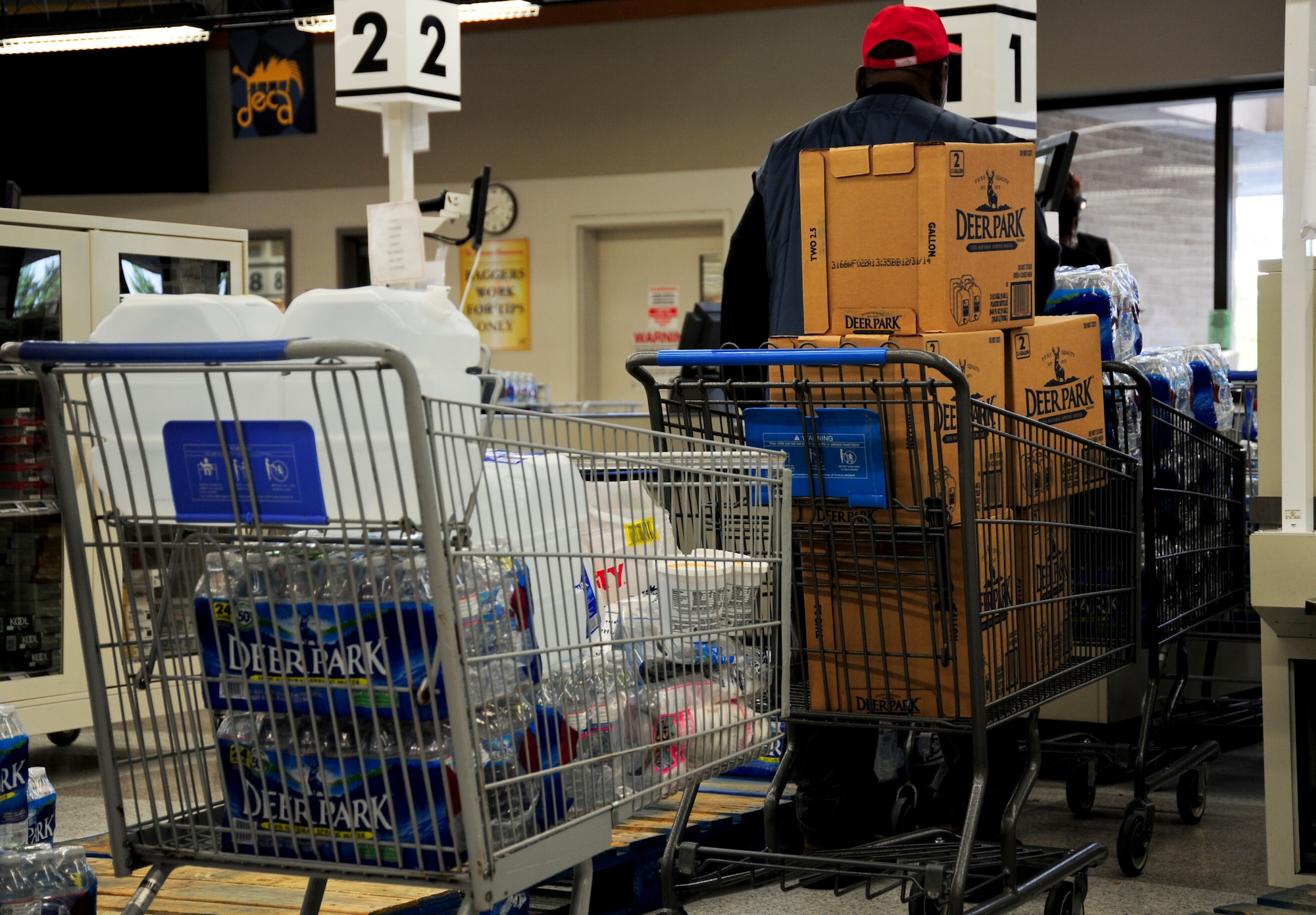 Customers wait in line to purchase water in preparation for a scheduled water outage at Joint Base Andrews, Md., July 16, 2013. Joint Base Andrews may be without water for two to five days while repairs are made due to a failing pipeline in Prince George’s County. (U.S. Air Force photo/Airman 1st Class Erin O’Shea) 	
