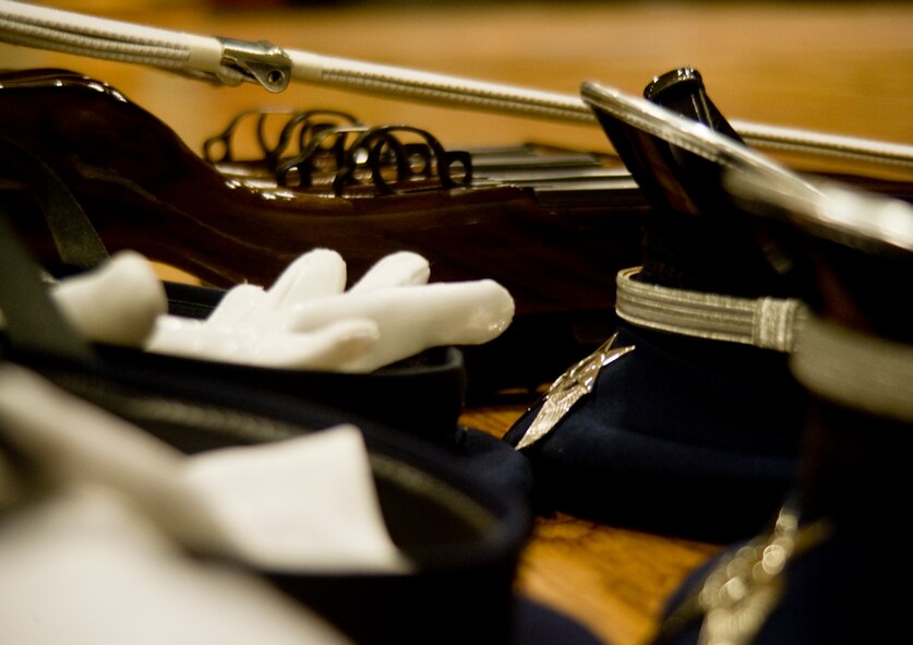 The hats, gloves and rifles of United States Air Force Honor Guard ceremonial guardsman lay neatly off to the side of the stage July 15, 2013, at Dyess Air Force Base, Texas. The Honor Guard presented their elite four-rifle routine at the base theater encouraging Dyess Airmen to apply to join. (U.S. Air Force photo by Airman 1st Class Peter Thompson/Released)