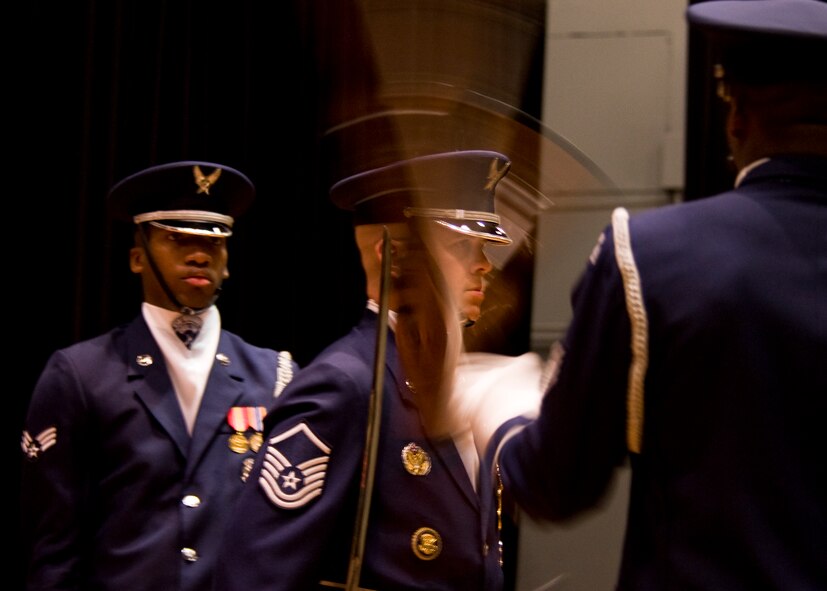 U.S. Air Force Ceremonial Honor Guardsmen spin their rifles with only inches of room between each other July 15, 2013, at Dyess Air Force Base, Texas. Ceremonial Guardsmen dedicate years to mastering ceremonial drill before becoming a part of the four-rifle routine. (U.S. Air Force photo by Airman 1st Class Peter Thompson/Released)