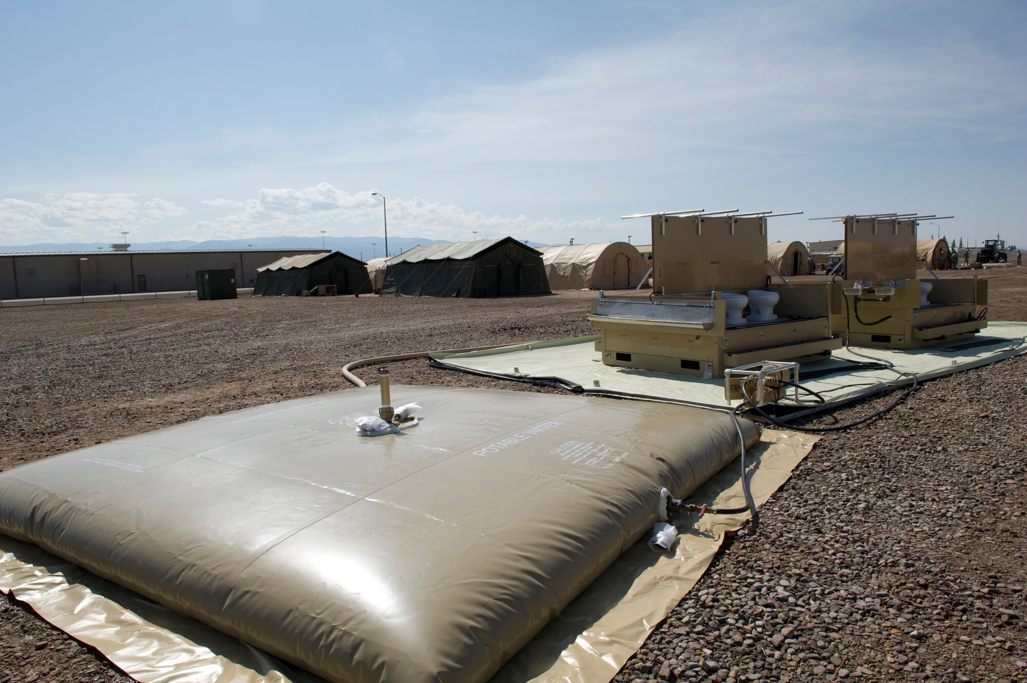 Members of the 49th Materiel Maintenance Squadron build a base from the ground up including lodging, latrines, laundry, showers, and dining facilities during a Basic Expeditionary Airfield Resources Base five-day training exercise at Holloman Air Force Base, N.M., July 10. The training mimicked conditions the Airmen would encounter at a deployed location. (U.S. Air Force photo by Senior Airman Kasey Close/Released)