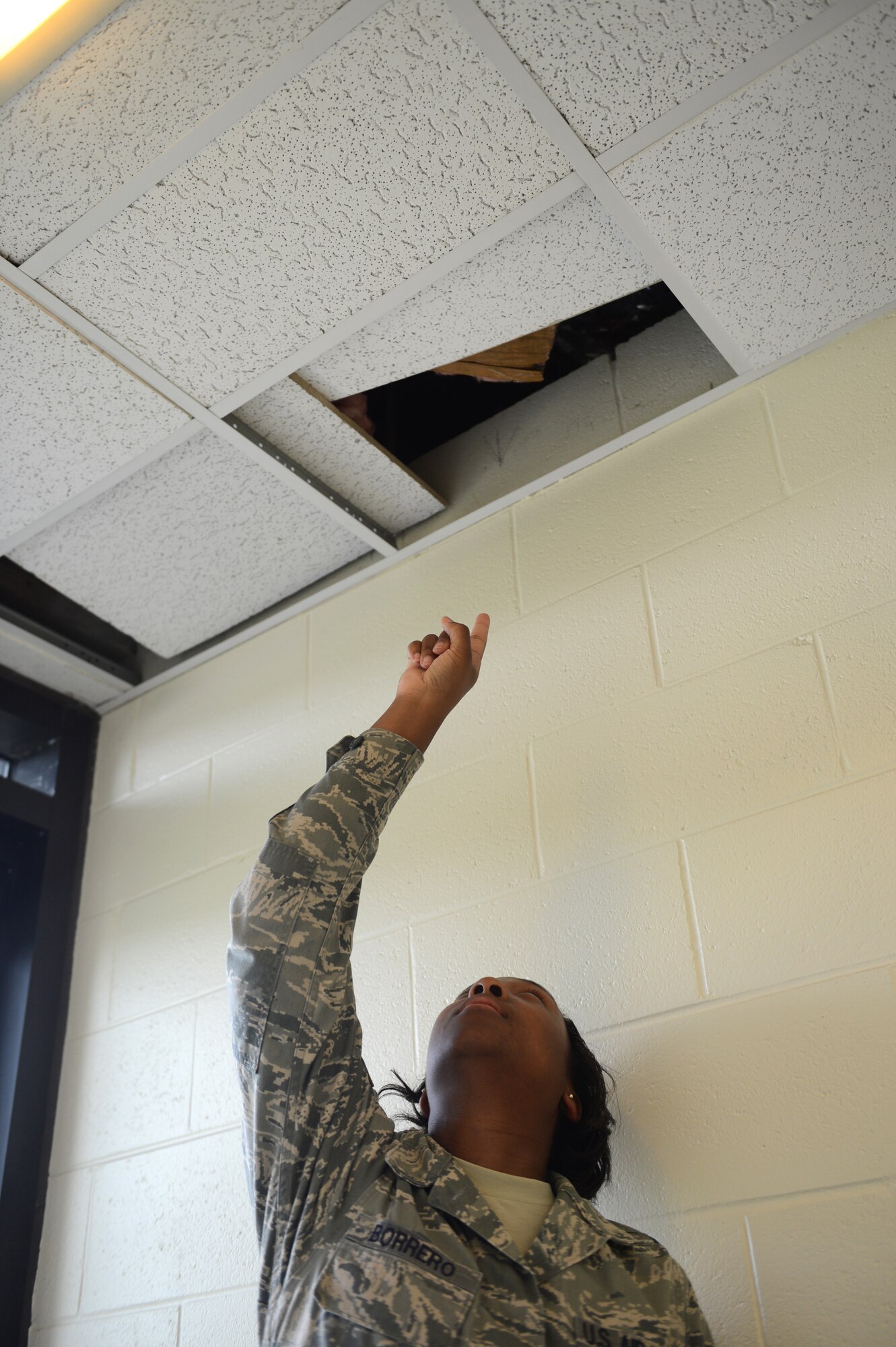 Tech. Sgt. Biagi Borrero (center), 20th Fighter Wing NCO in charge of ground safety, discovers a potential fire hazard during a spot inspection at Shaw Air Force Base, S.C., July 12, 2013. The wing safety office conducts spot inspections to indentify safety hazards and ensure Air Force Instruction compliance. (U.S. Air Force photo by Airman 1st Class Daniel Blackwell/Released)