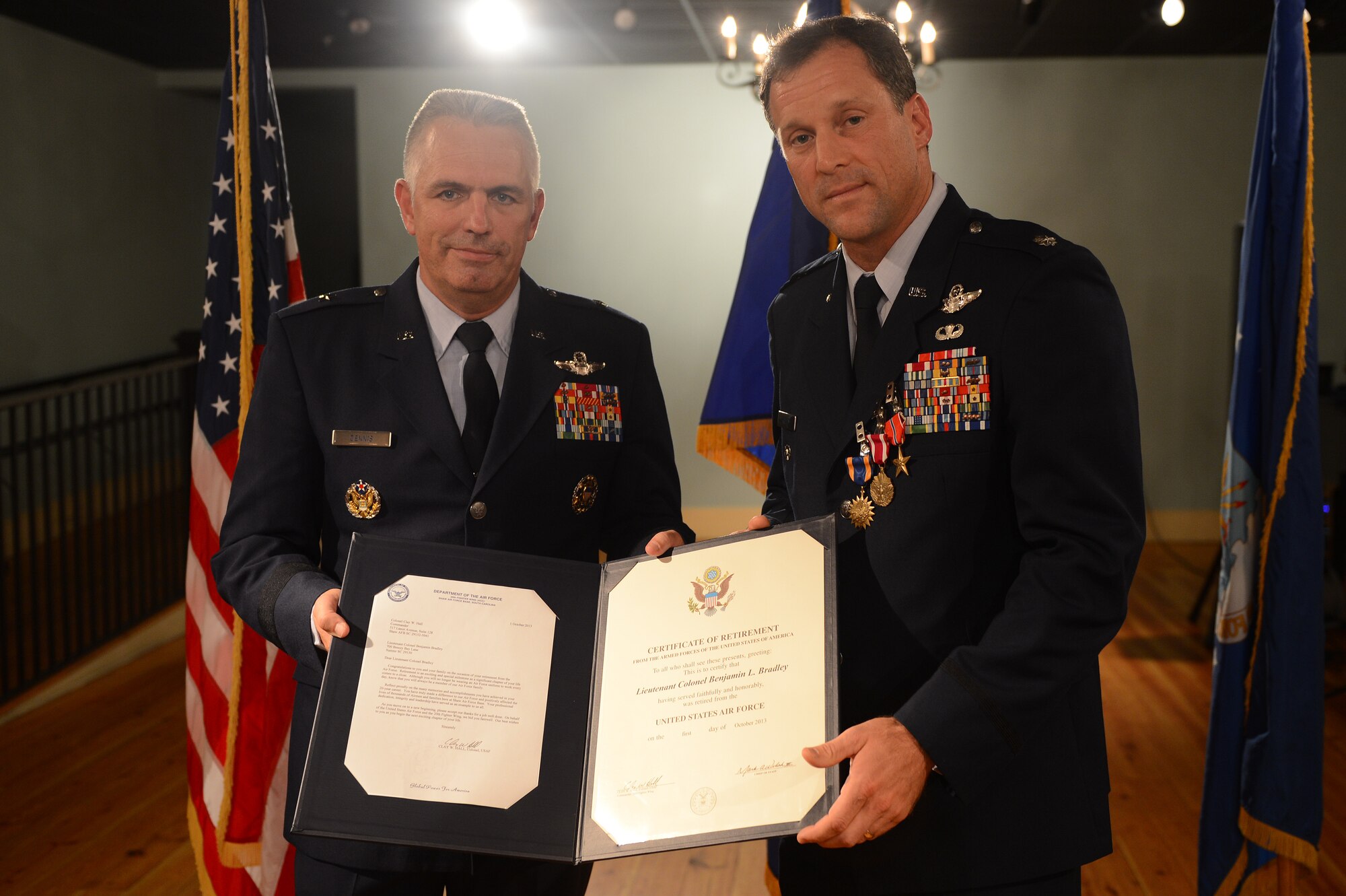 Brig. Gen. Scott L. Dennis (left), presents Lt. Col. Benjamin  Bradley with his certificate of retirement during his retirement ceremony in Sumter, S.C., July 12, 2013. In addition to his retirement certificate, Bradley also received The Air Medal (Third Oak Leaf Cluster), The Meritorious Service Medal (First Oak Leaf Cluster), The Bronze Star Medal and a certificate of appreciation signed by President Obama. (U.S. Air Force photo by Airman 1st Class Daniel Blackwell/Released)