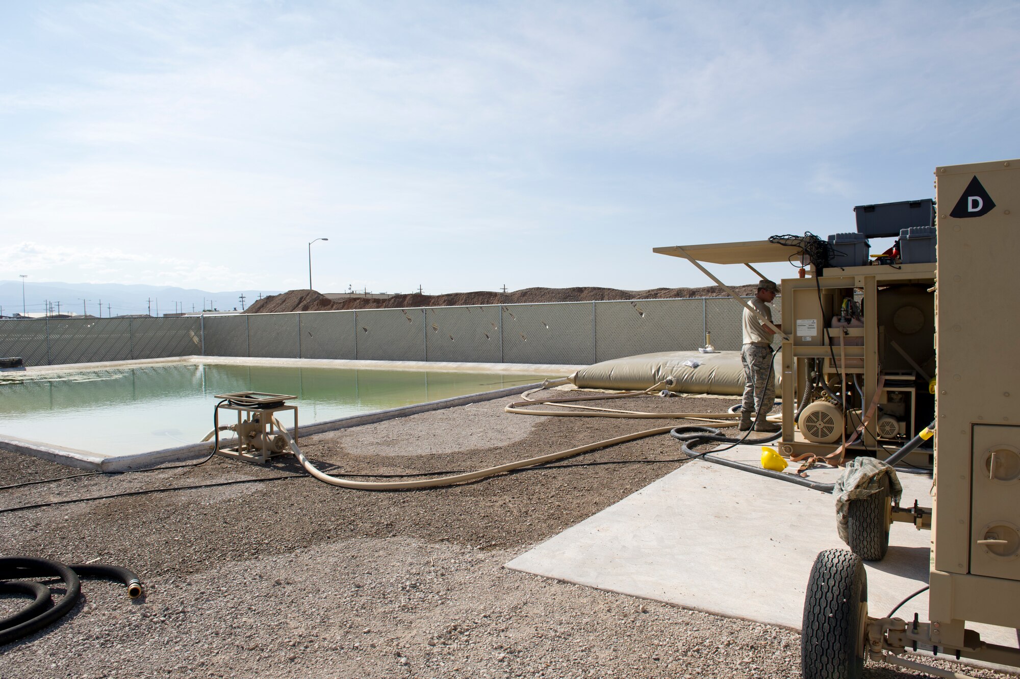 Senior Airman Trevor Dickerson, 49th Materiel Maintenance Squadron utilities shop journeyman, starts a reverse osmosis water purification system during a Basic Expeditionary Airfield Resources Base five-day training exercise at Holloman Air Force Base, N.M., July 10. The system allows Dickerson to retrieve water from a natural source and produce drinking water. (U.S. Air Force photo by Senior Airman Kasey Close/Released)
