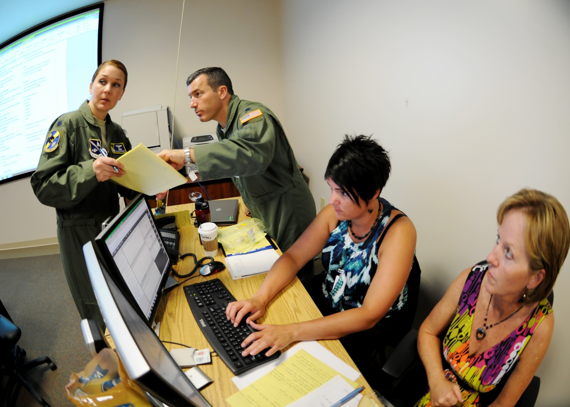 Members of the Crisis Action Team review notes and update plans during a meeting with senior leaders at Joint Base Andrews, Md., July 16, 2013.  Joint base Andrews may be without water for two to five days while repairs are made to a failing pipeline located in Prince George's County. (U.S. Air Force photo/Staff Sgt. Nichelle Anderson) 