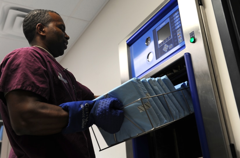 U.S. Air Force Tech. Sgt. Rudy Grajales, 633rd Dental Squadron technician, removes clean instruments from the sanitizing machine at the dental clinic on Langley Air Force Base, Va., July 10, 2013. Although the majority of cases the oral and maxillofacial surgeons at the clinic see are wisdom tooth extractions or dental implants, the facility is equipped to perform corrective jaw surgery, sleep apnea treatment and trauma care. (U.S. Air Force photo by Airman 1st Class Kimberly Nagle/Released)