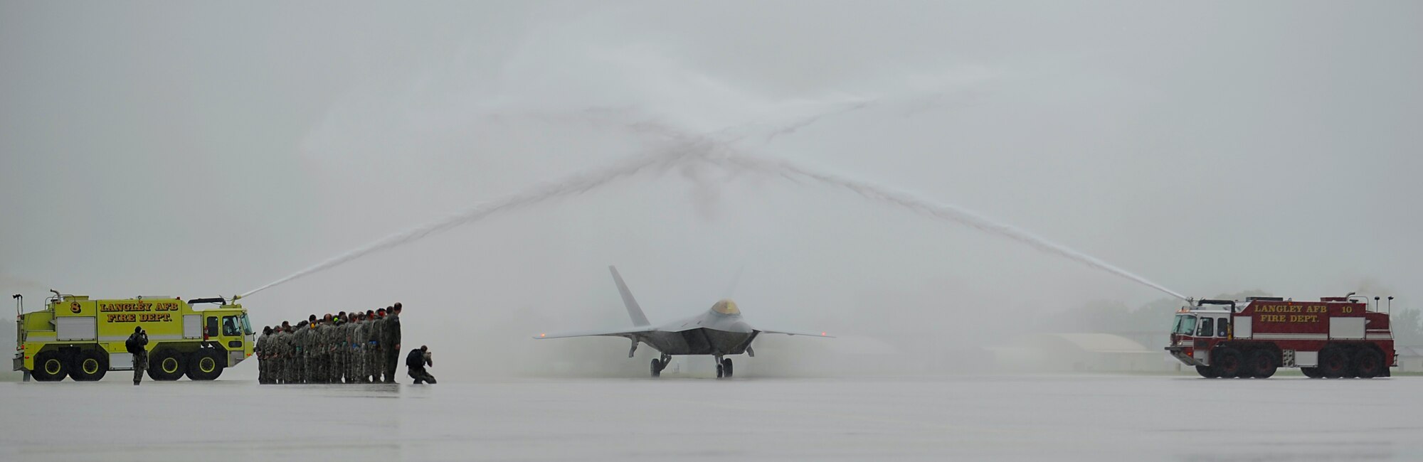 An F-22 Raptor piloted by U.S. Air Force Col. Kevin J. Robbins, 1st Fighter Wing commander, passes beneath an arc of water after his “fini flight” at Langley Air Force Base, Va., July 12, 2013. Robbins has flown more than 250 combat hours in support of Operations Desert Storm, Desert Shield and Southern Watch. (U.S. Air Force photo by Airman 1st Class Victoria H. Taylor/Released)
